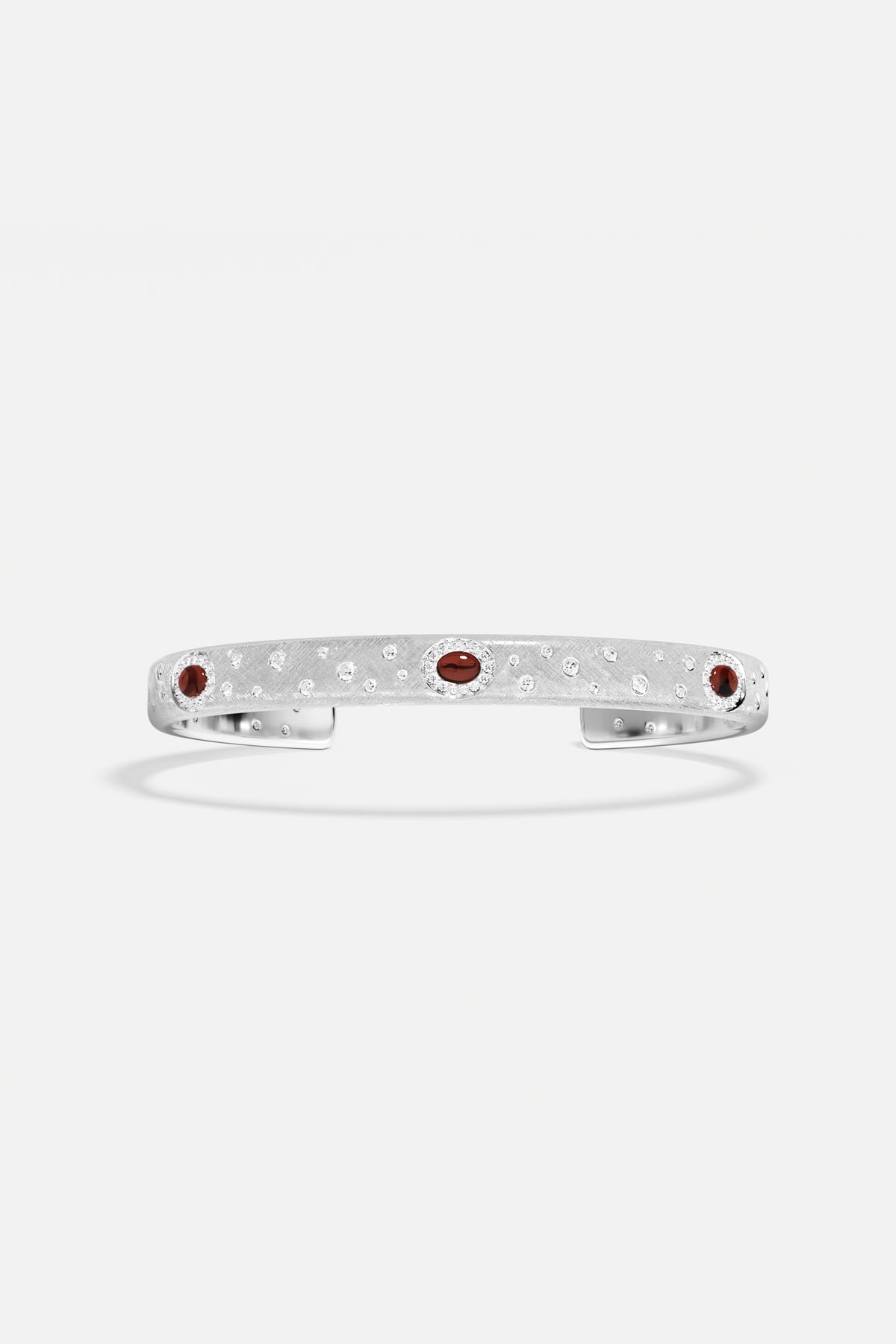 APM Monaco cuff bracelet in rhodium finish, sprinkled with sparkle and deep red accents.