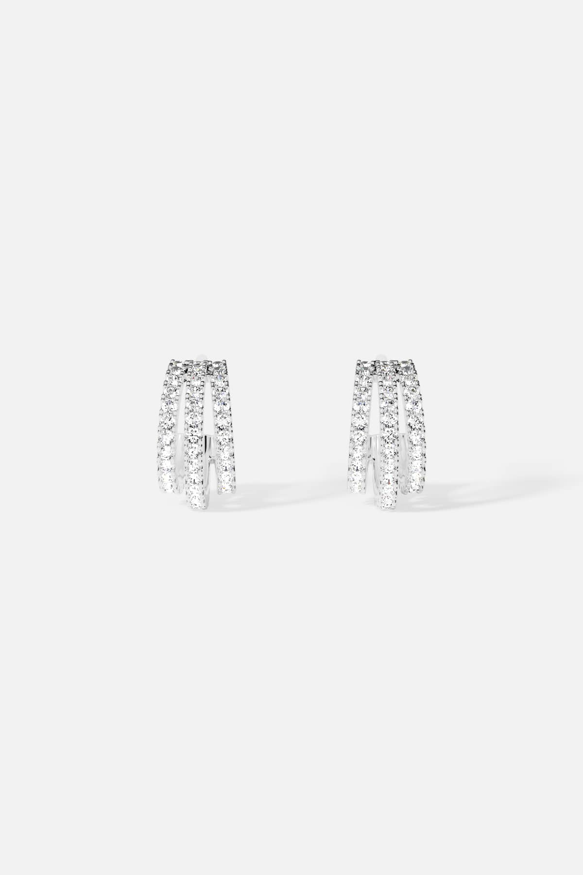 APM Earrings, triple arcs of shimmer in a rhodium finish, quietly radiant.