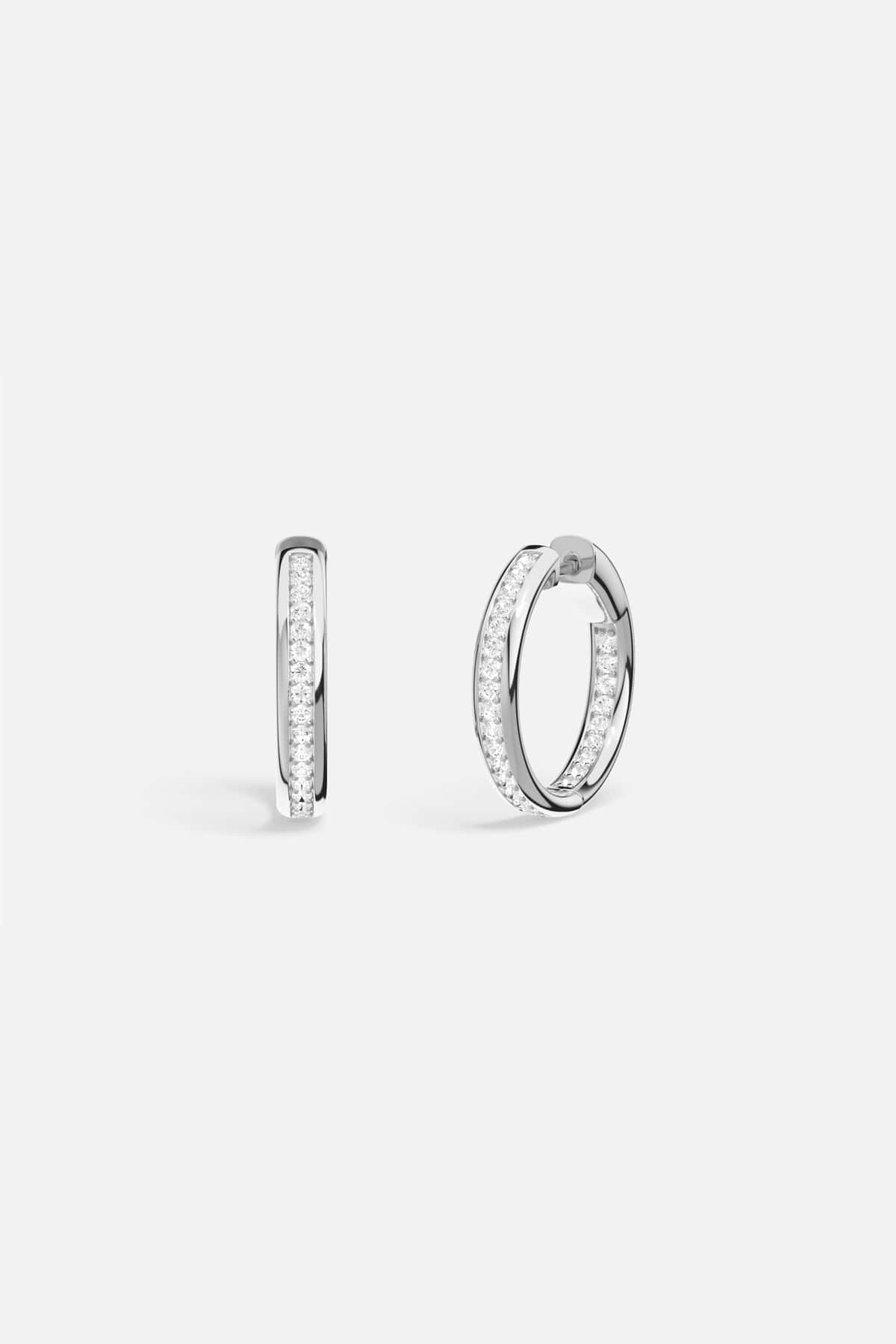 APM Hoop Earrings, a luminous rhodium finish circle for effortless everyday radiance.