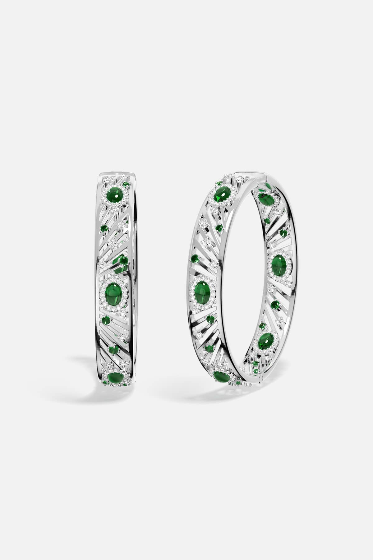 APM Bangles in rhodium finish with emerald green stones, radiant elegance with a modern edge.