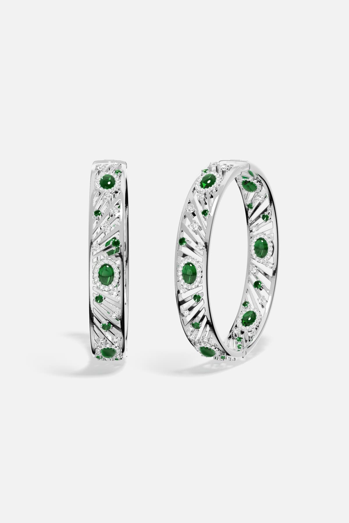 APM Bangles in rhodium finish with emerald green stones, radiant elegance with a modern edge.