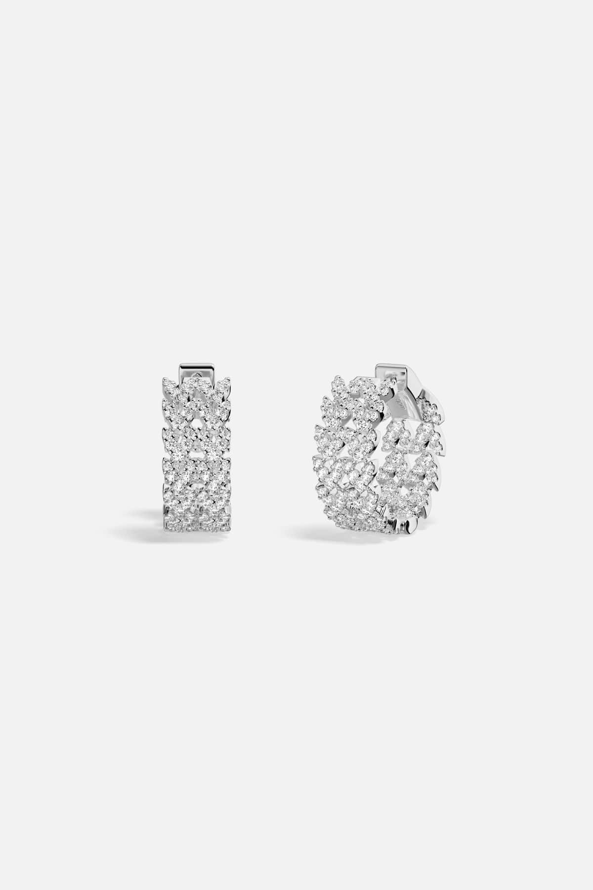 APM Hoop Earrings shimmering with rhodium finish, a modern touch of effortless sparkle.