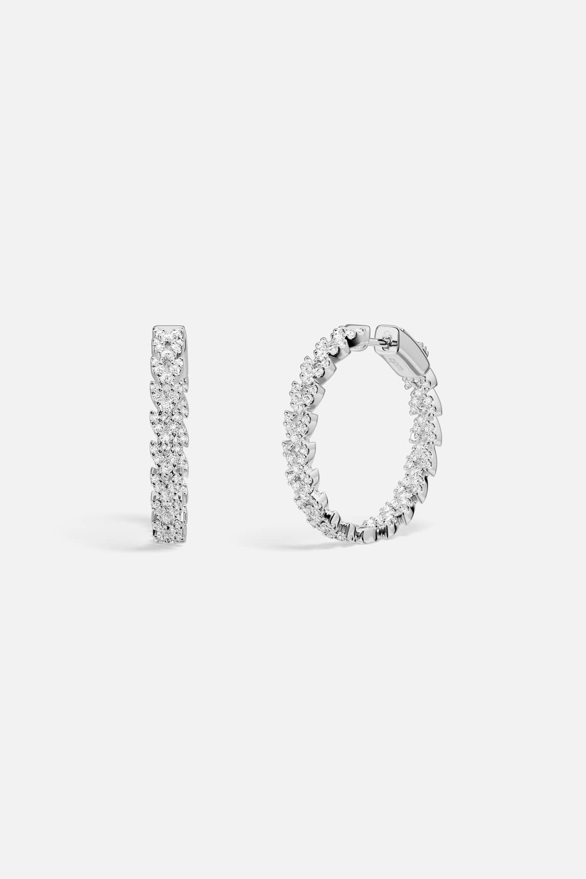 APM Hoop Earrings, a shimmering cascade of brilliance in rhodium finish.