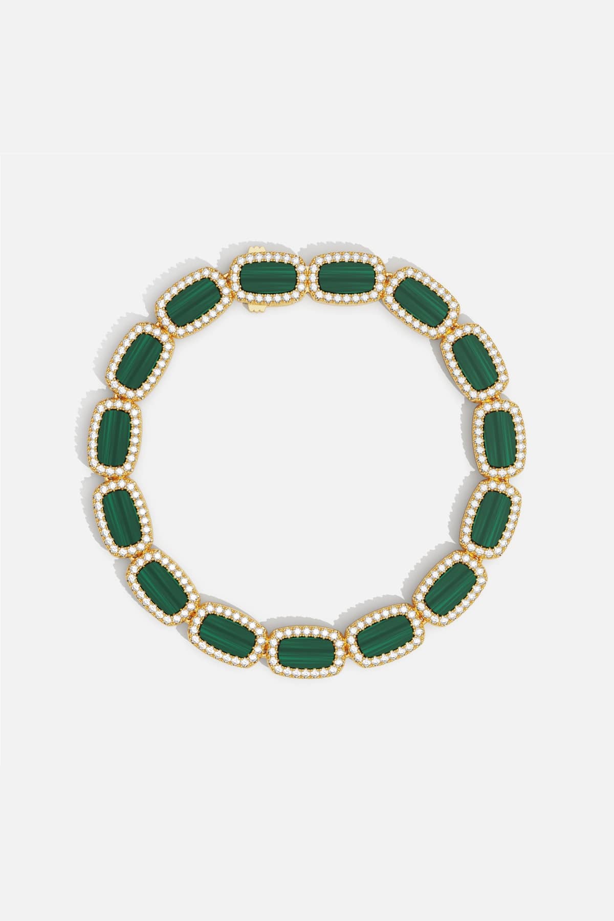 APM Monaco bracelet in golden hues, framing rich green stones with quiet elegance.