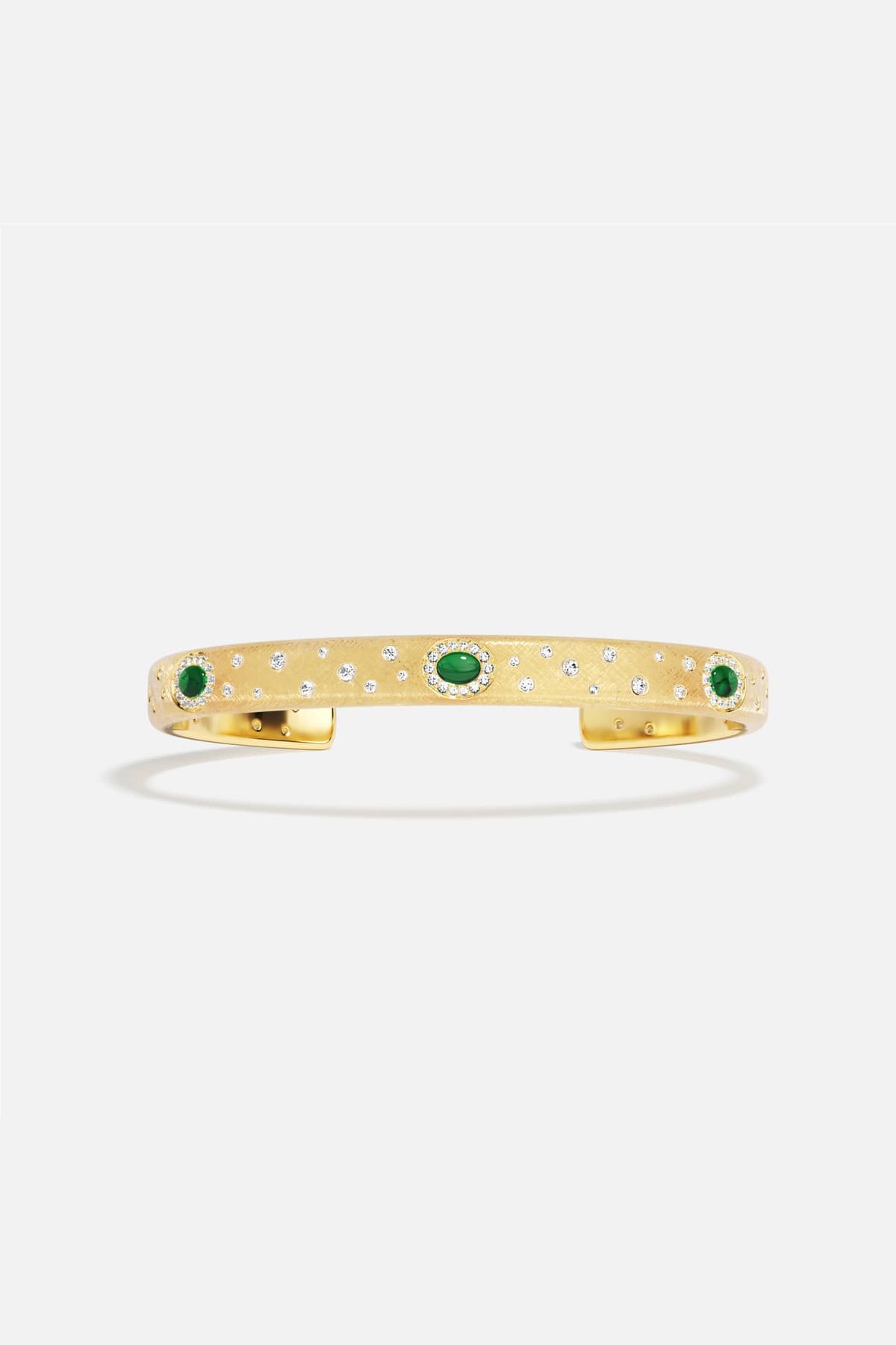 APM Monaco cuff bracelet in golden hues, scattered with emerald green stardust.