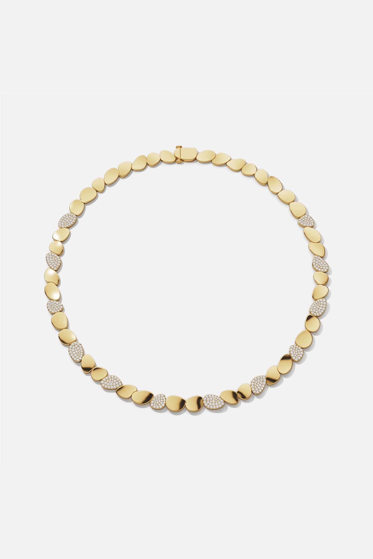 APM Necklace in warm gold color, smooth pebbles glinting with quiet radiance.