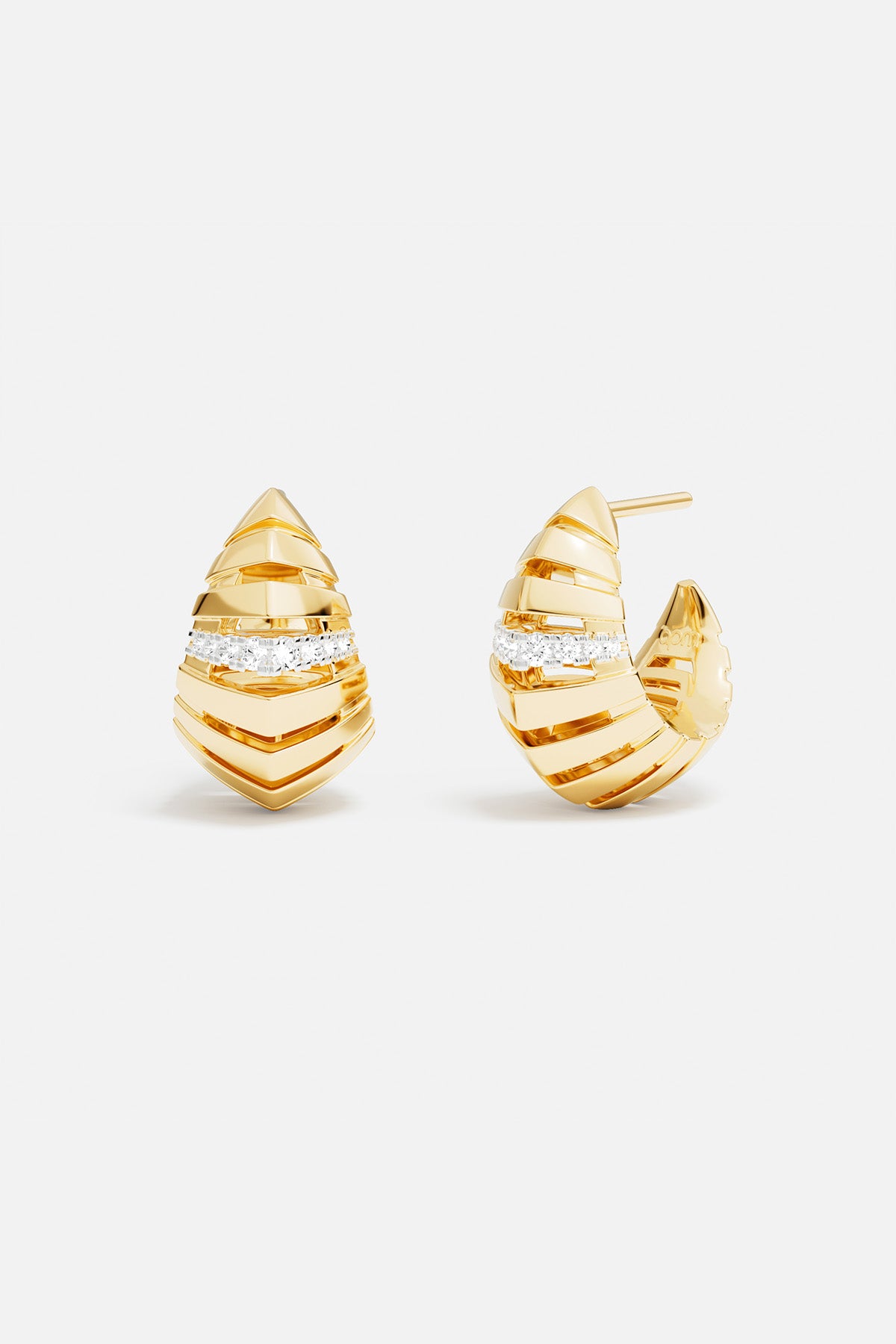 APM Monaco earrings in golden hues, sculpted lines meeting a shimmering embrace of light.