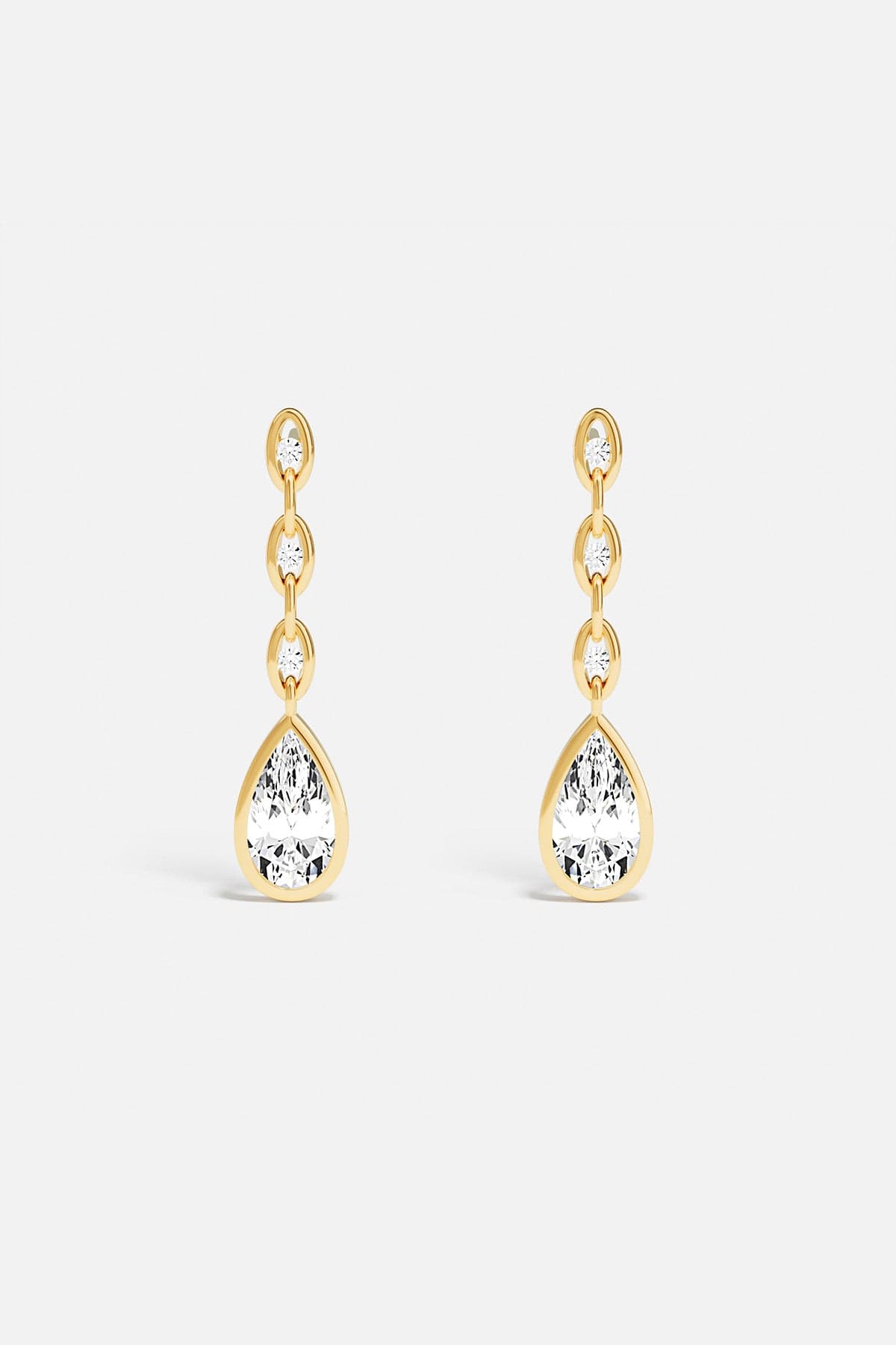 APM drop earrings, a golden cascade ending in luminous elegance.