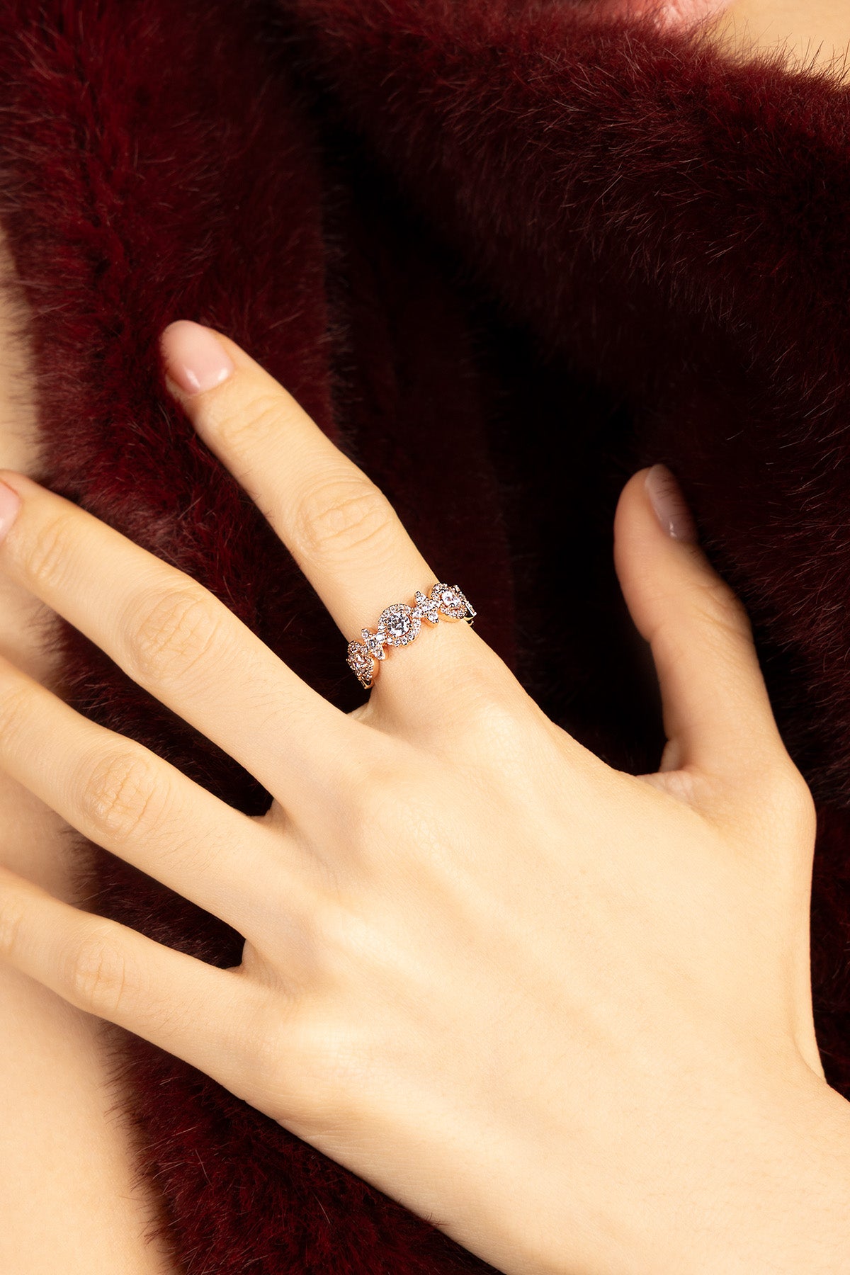 Woman wearing APM ring, a delicate sparkle against soft winter warmth.