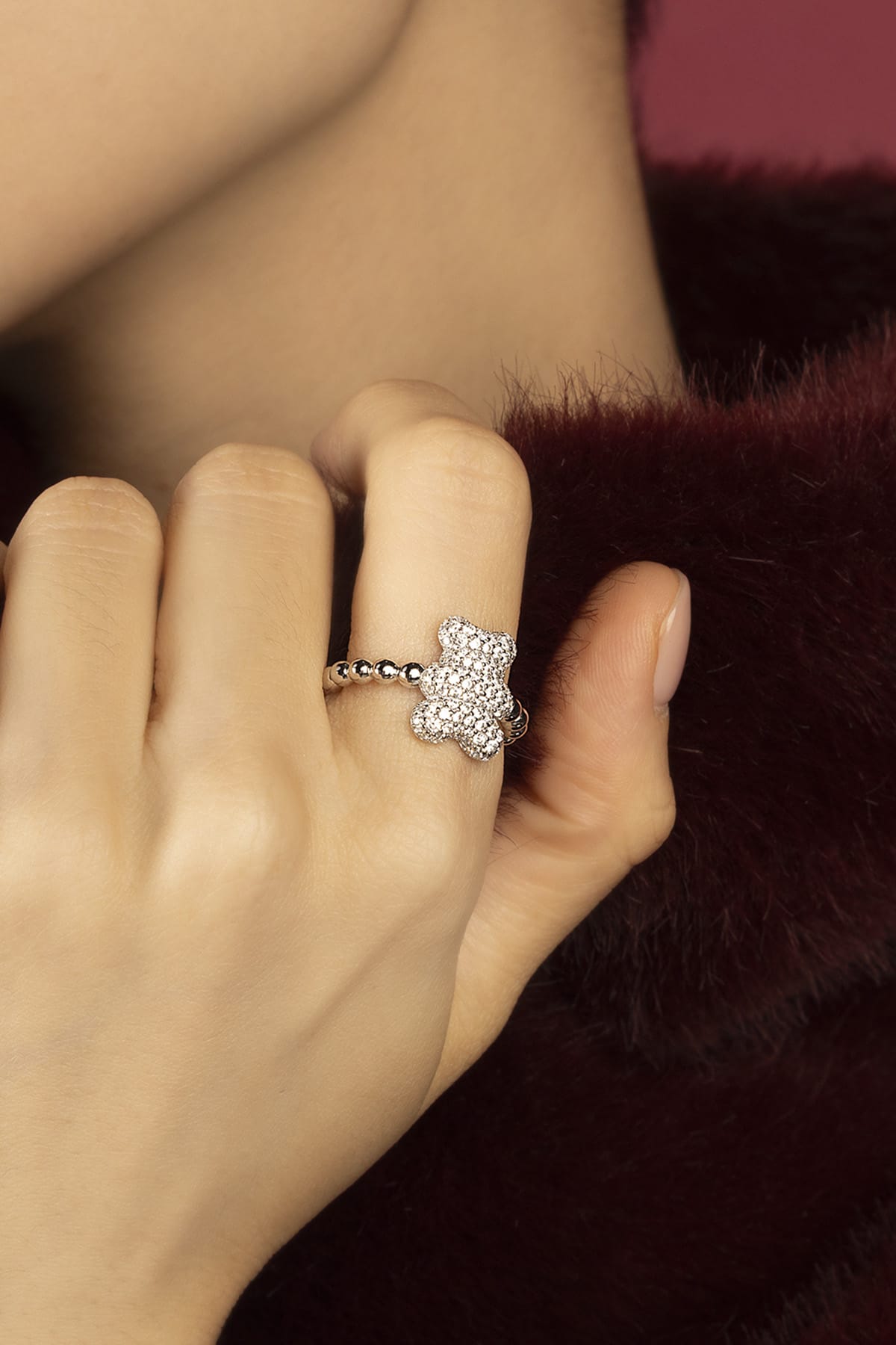 Woman wearing APM bear ring, playful sparkle meets soft everyday charm.
