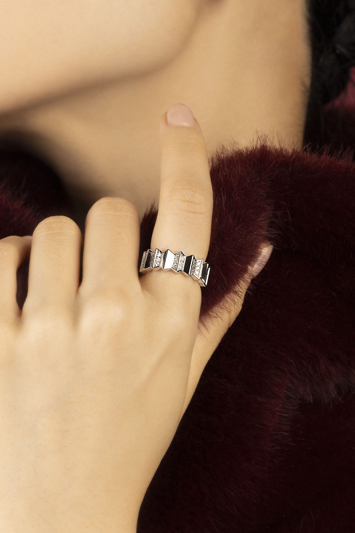 Woman wearing APM Morse Ring, a geometric rhythm of rhodium finish and sparkle.