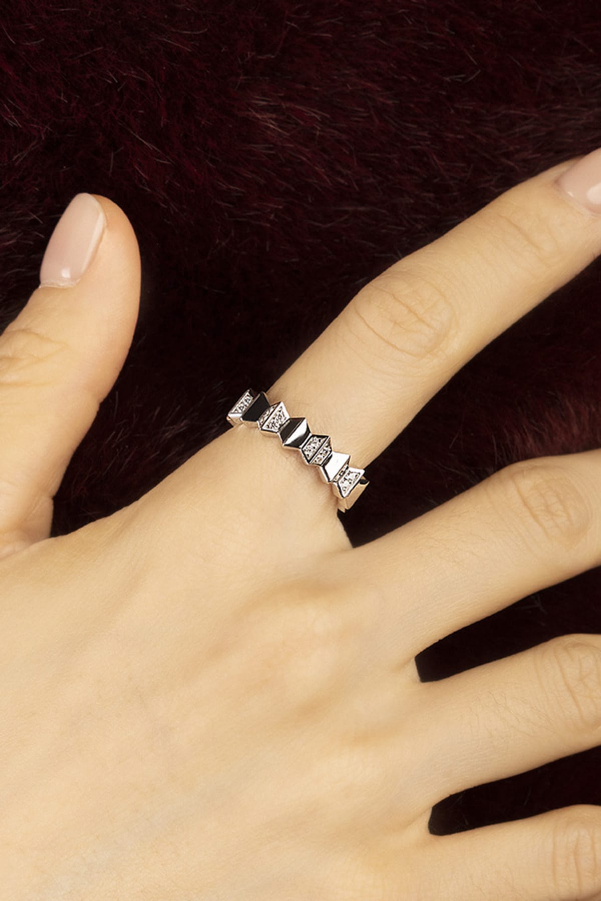 Woman wearing APM Morse Ring, geometric edge in rhodium finish, quiet elegance.