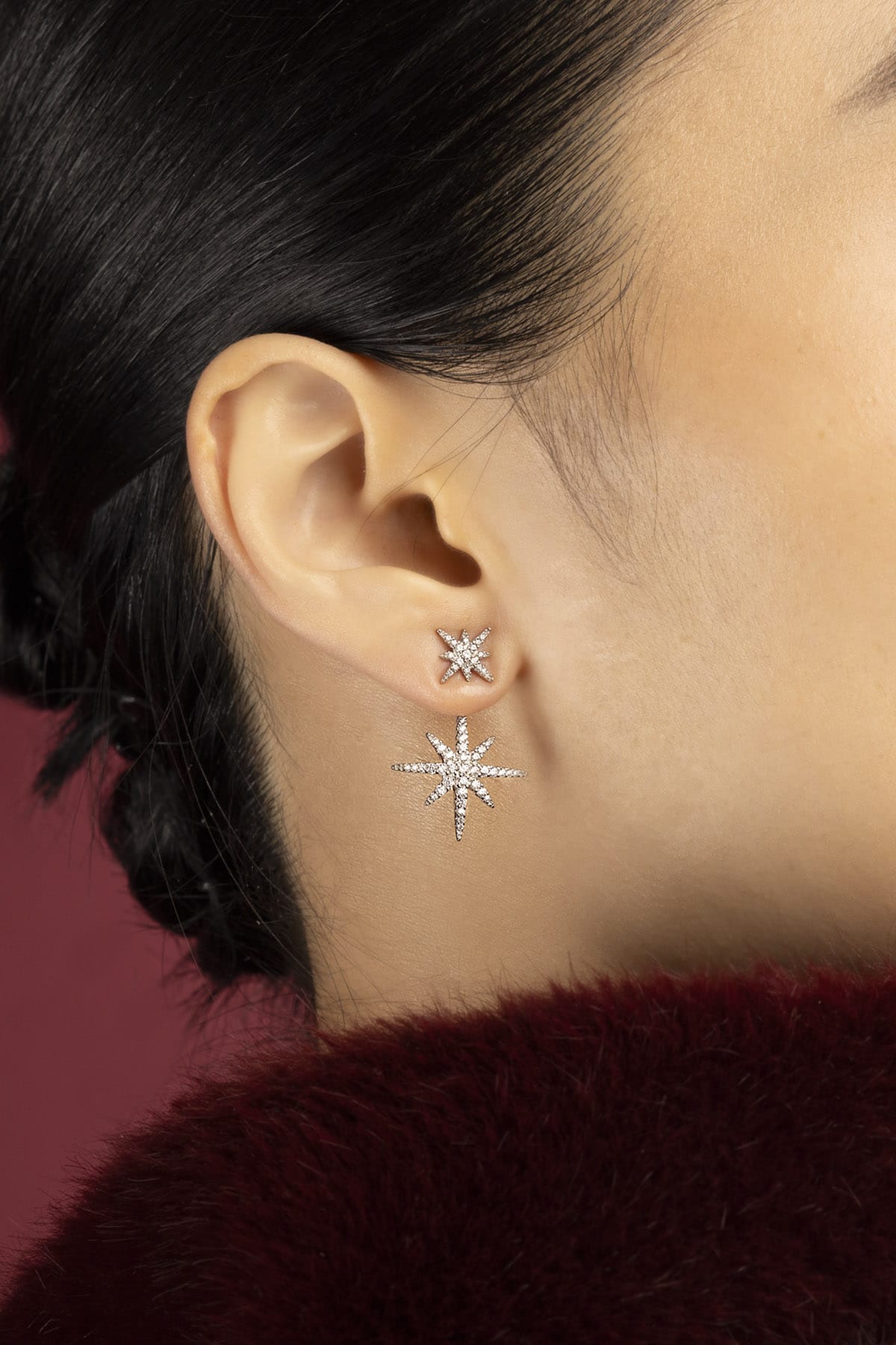 Woman wearing APM Météorites Earrings, a constellation of sparkle drifting close to skin.