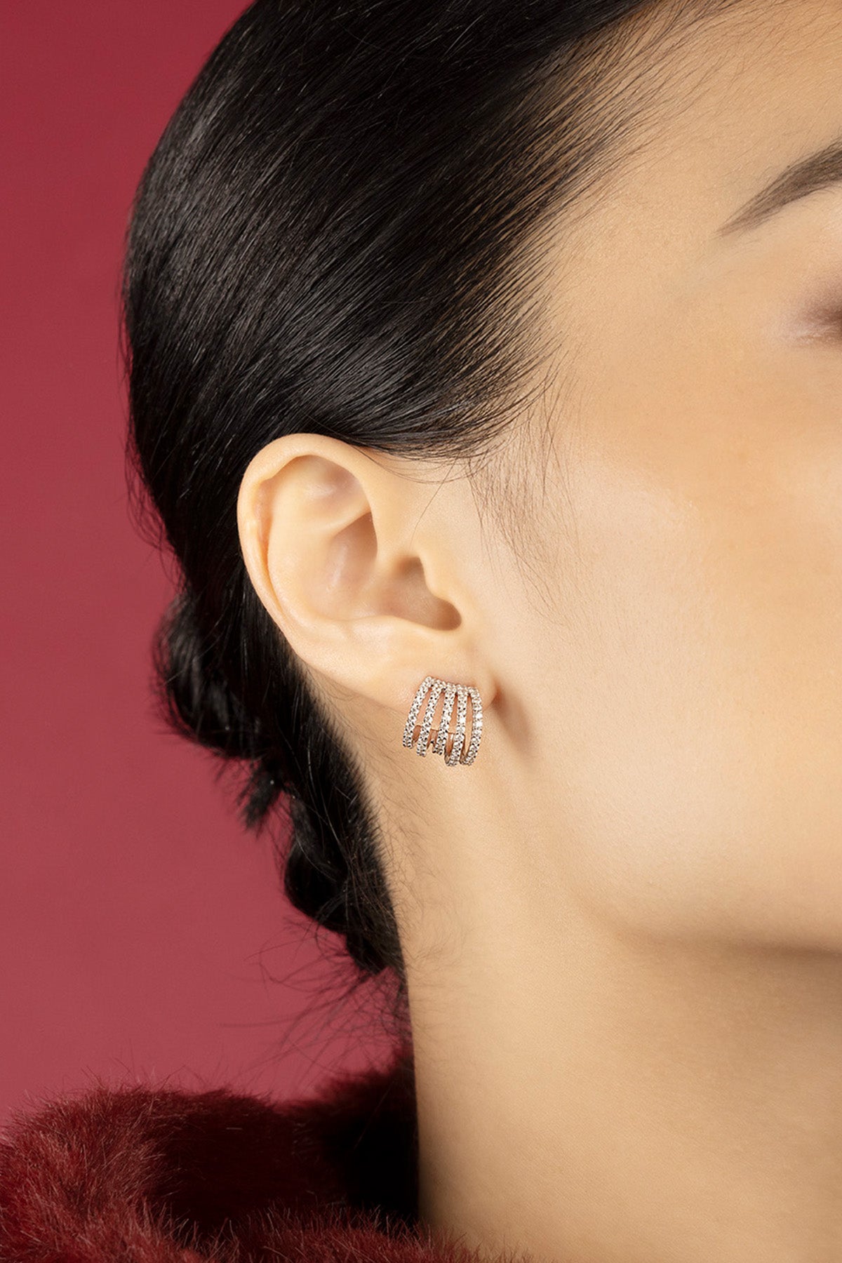 Woman wearing APM multi-row Earrings, a shimmering whisper of modern elegance.