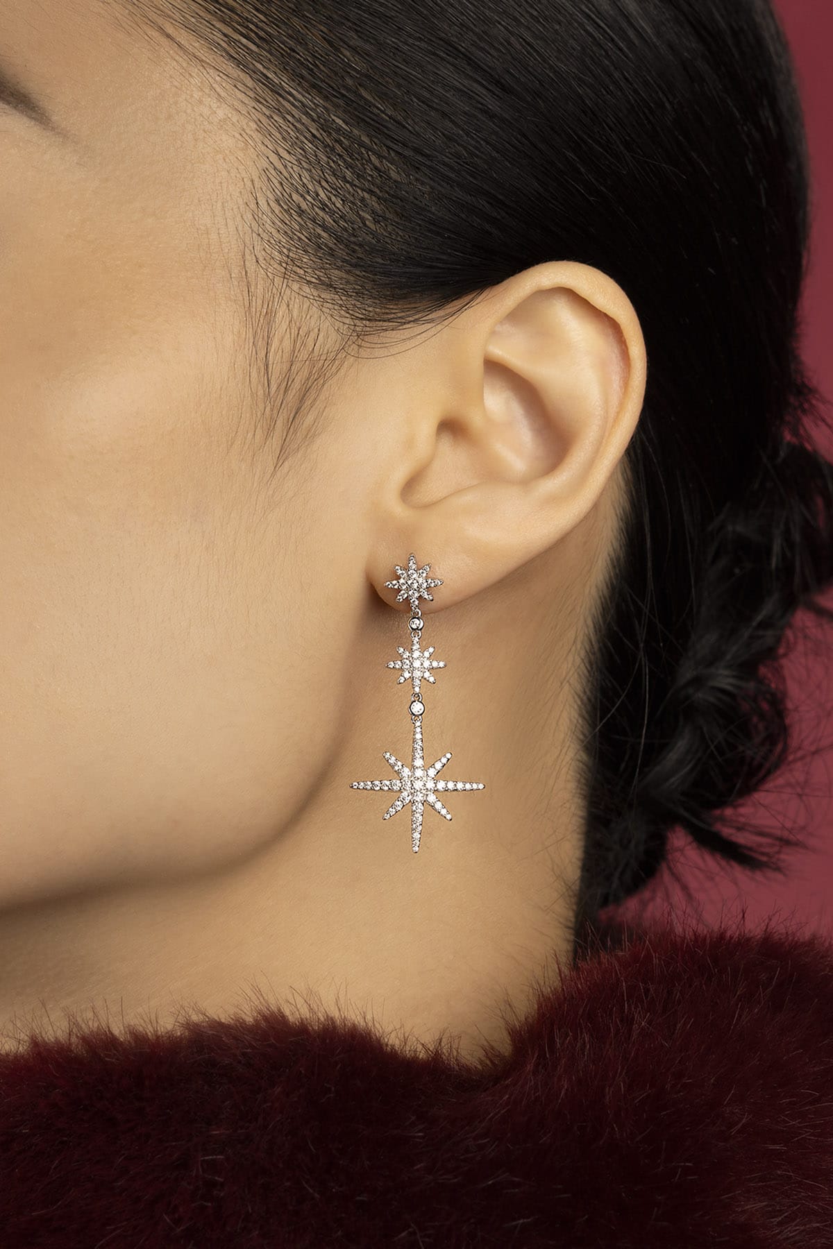 Woman wearing APM Météorites earrings, a cascade of stars lighting the night.