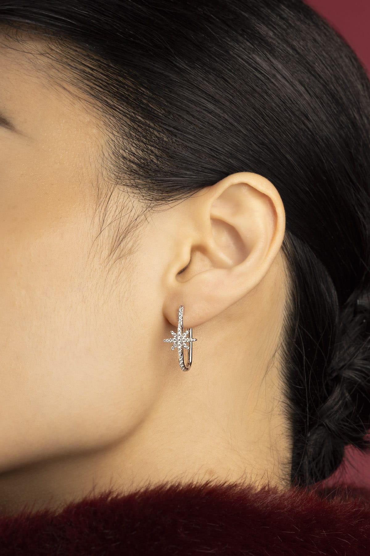 Woman wearing APM Météorites Hoop Earrings, a starlit whisper of quiet elegance.