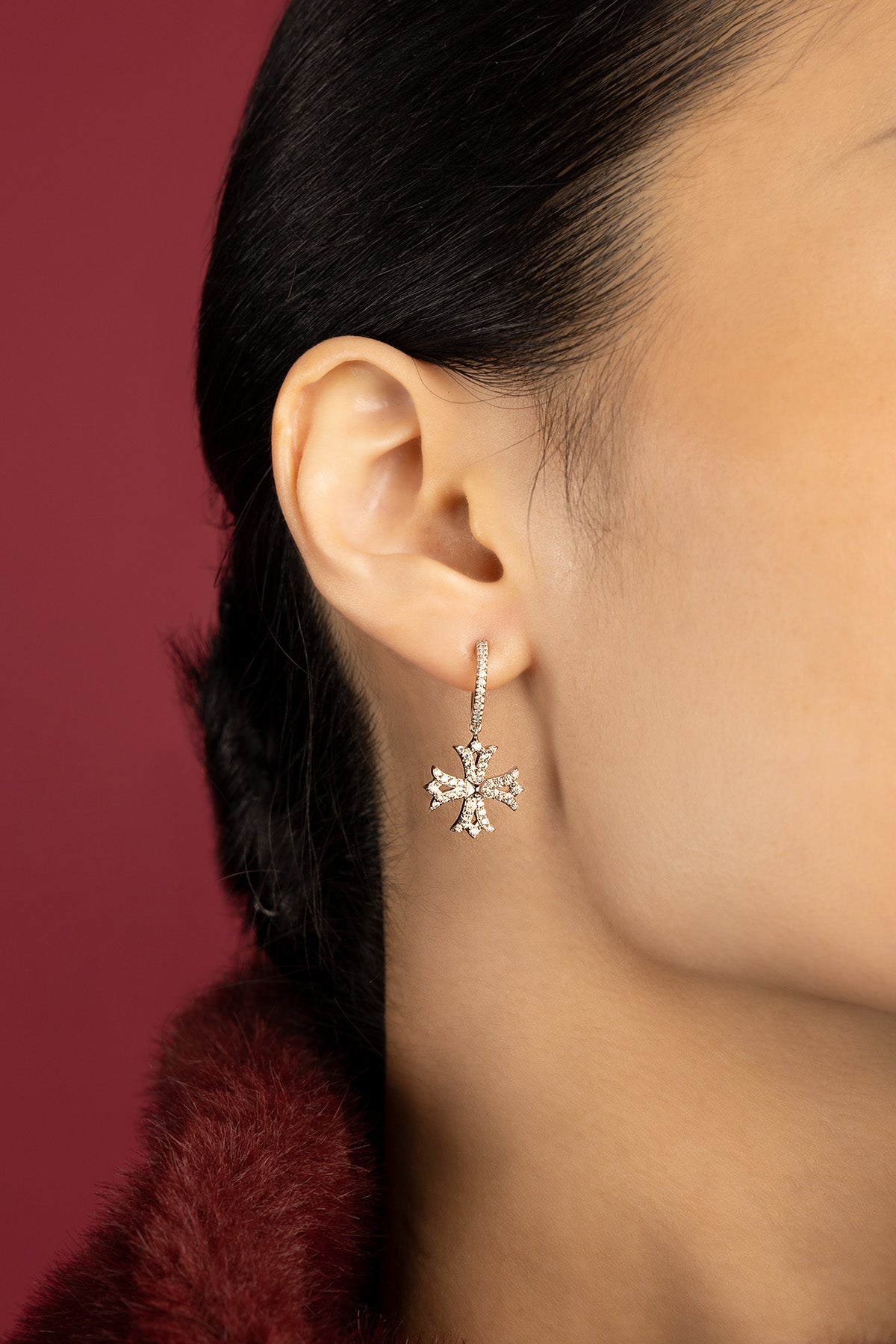 Woman wearing APM earrings, a delicate sparkle framing quiet elegance.