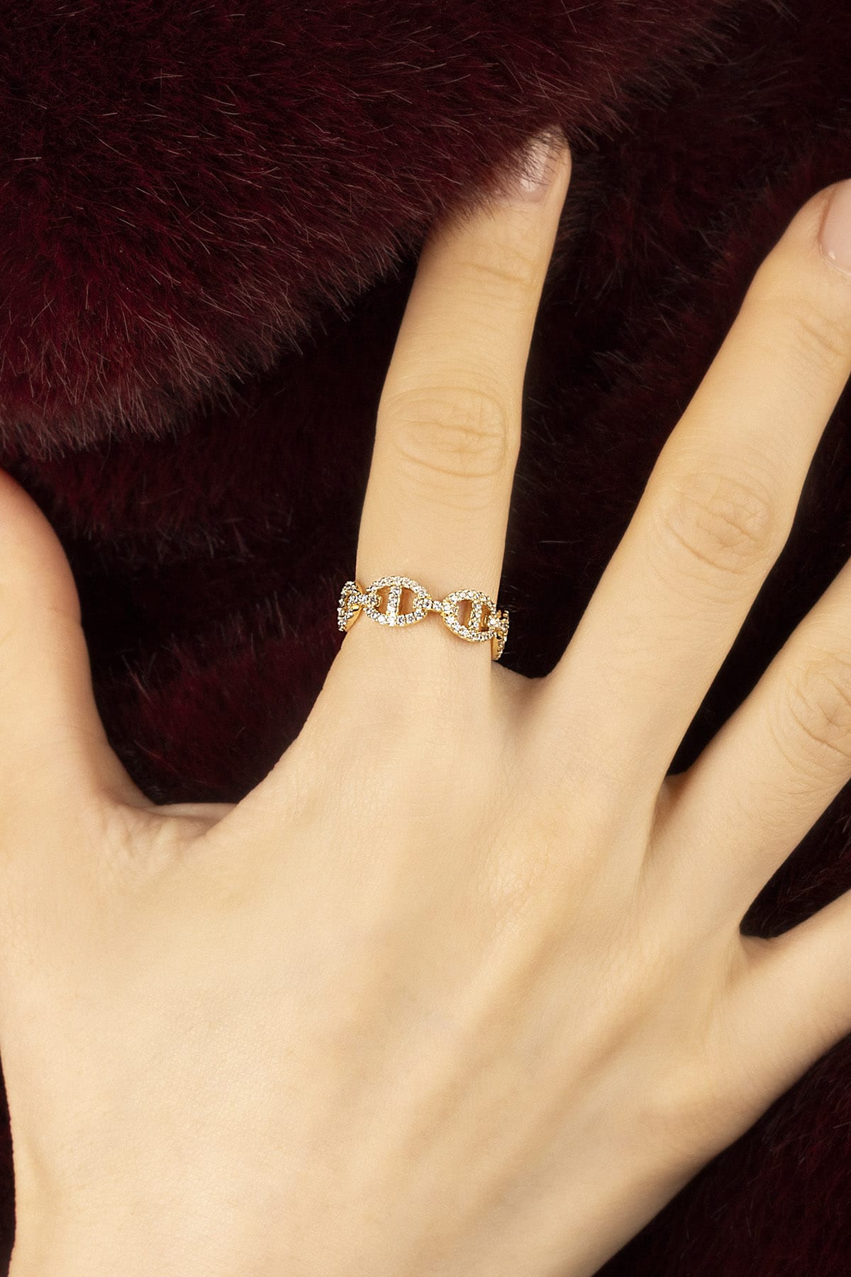 Woman wearing APM Morse Ring, a golden whisper of linked elegance.
