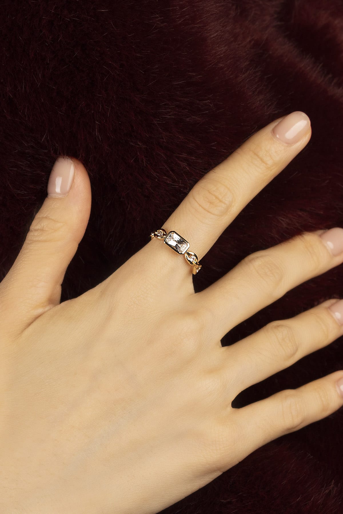 Woman wearing APM ring, a golden whisper of quiet elegance.