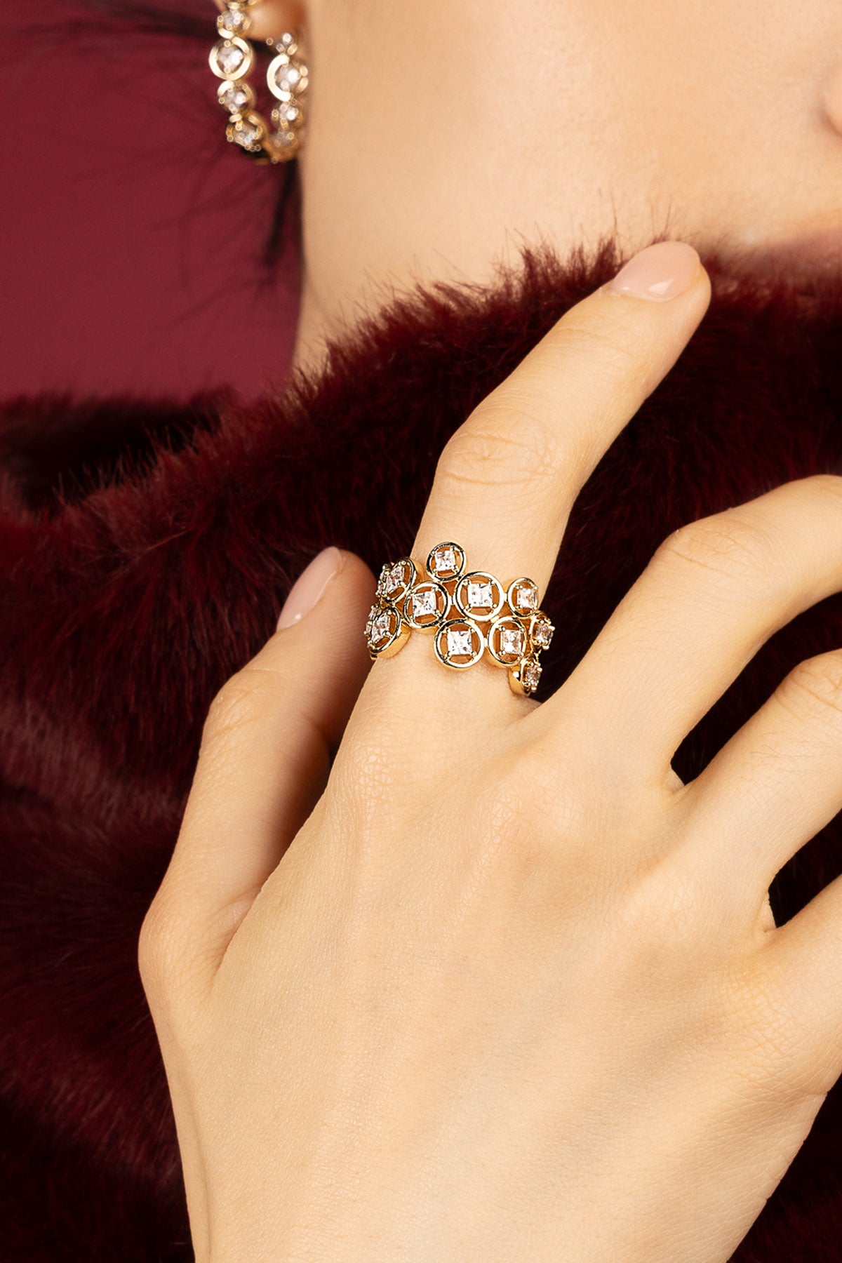 Woman wearing APM Ring, a golden constellation shimmering against velvet warmth.