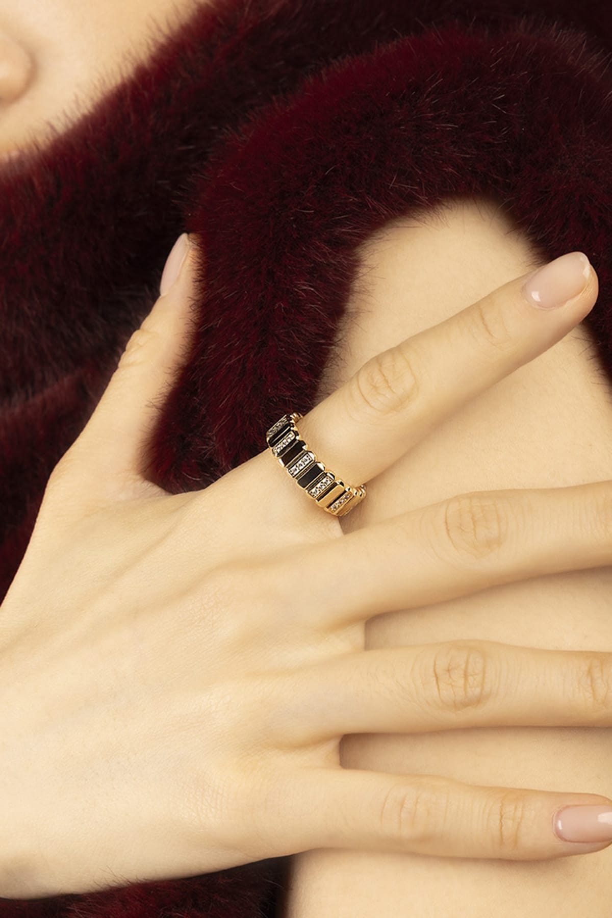 Woman wearing APM Morse Ring, a golden whisper of quiet elegance.
