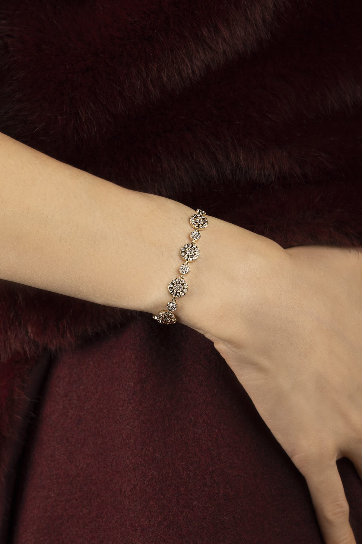 Woman wearing APM Morse Bracelet, a golden whisper of celestial charm.