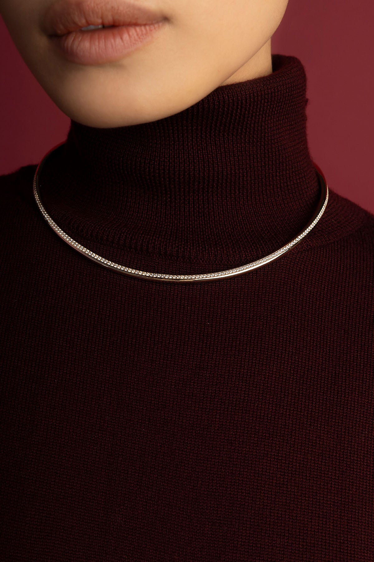 Woman wearing APM Monaco choker necklace, a sleek line of quiet elegance.