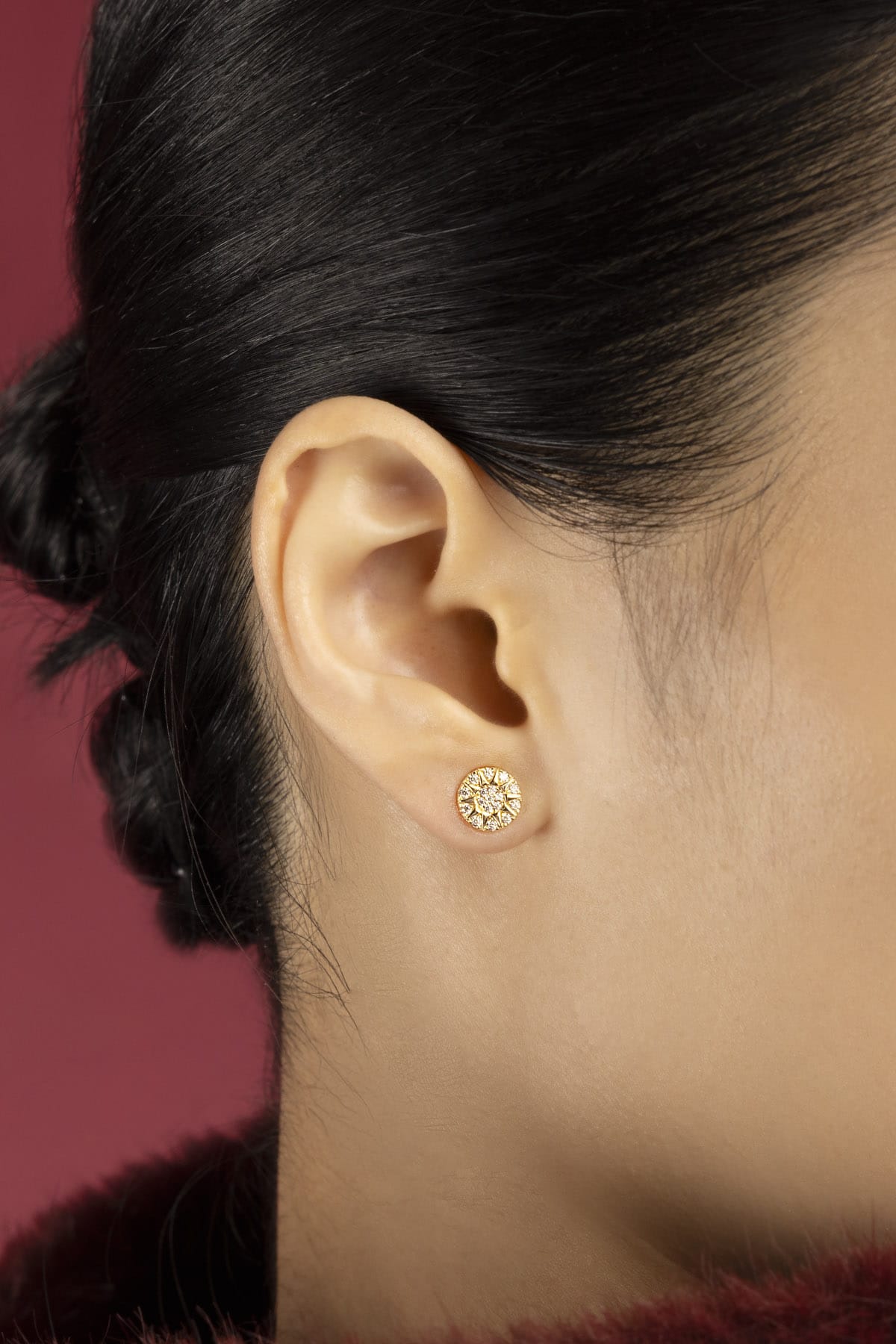Woman wearing APM Morse Earrings, a radiant whisper of golden elegance.