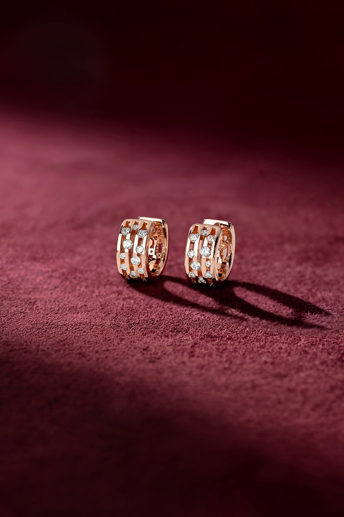 APM Hoop Earrings, a rose-hued glow with sparkling accents on velvet luxury.