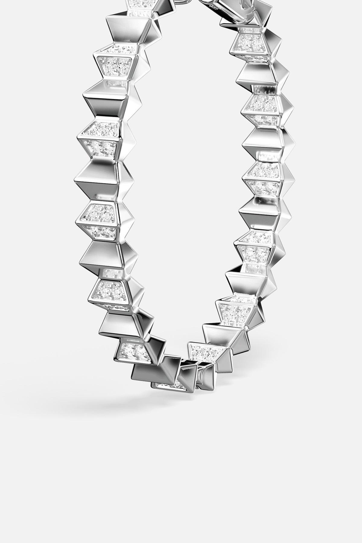 APM hoop earrings in rhodium finish, sculpted geometry with a bold modern edge.
