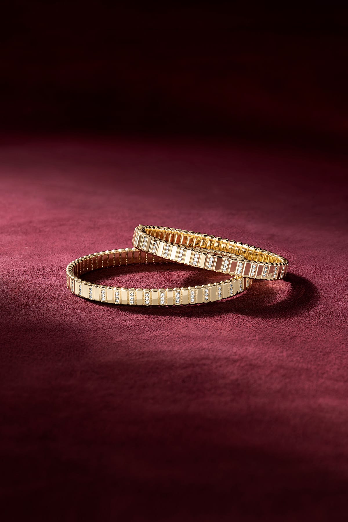 APM Monaco bracelets in golden color, radiant elegance on velvet.