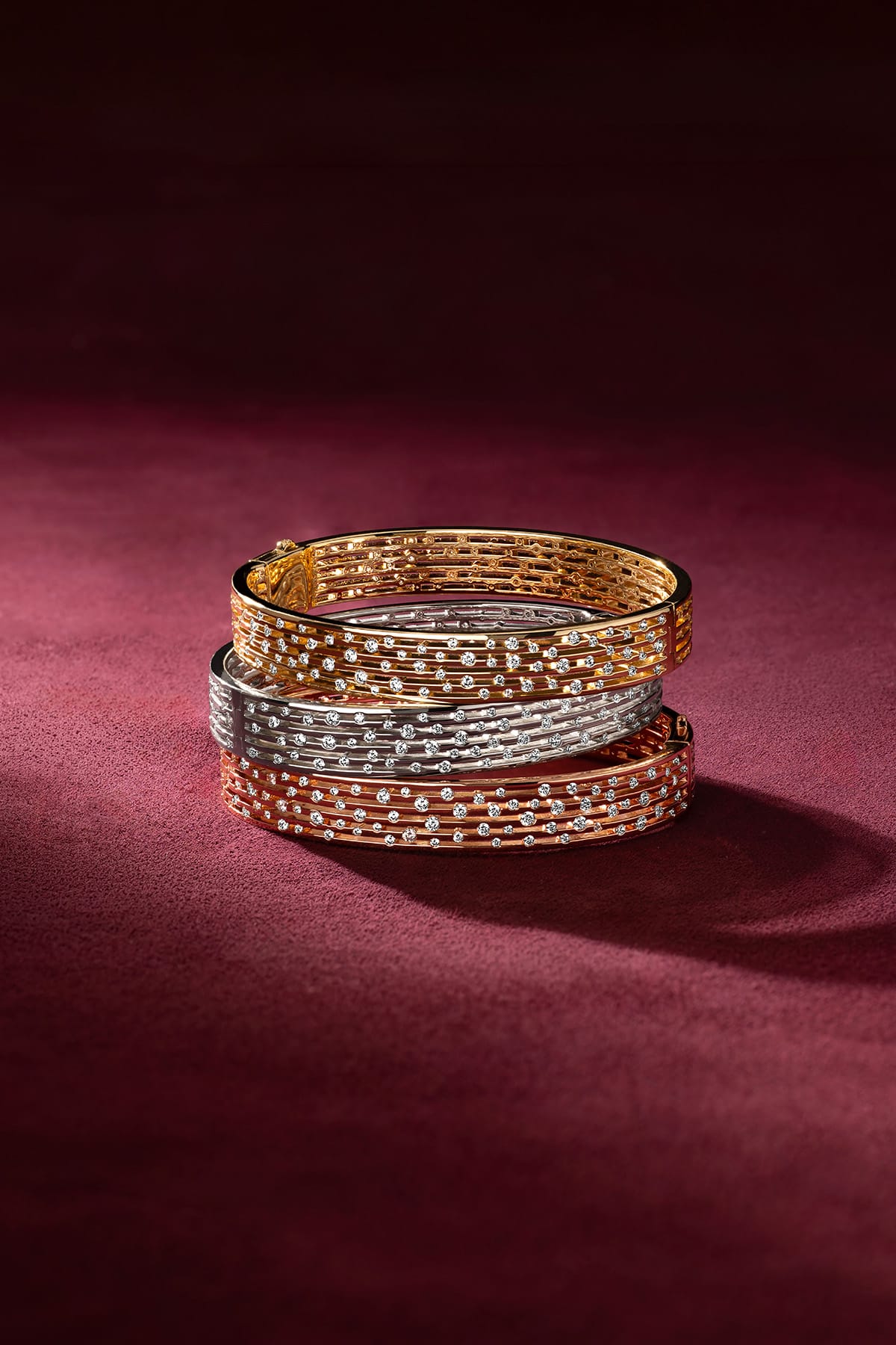 APM Bangles stacked in three colors, shimmering like a starlit night.