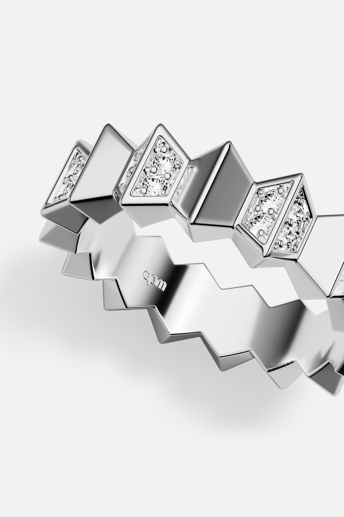 APM zigzag ring in rhodium finish, sharp geometry meets quiet sparkle.