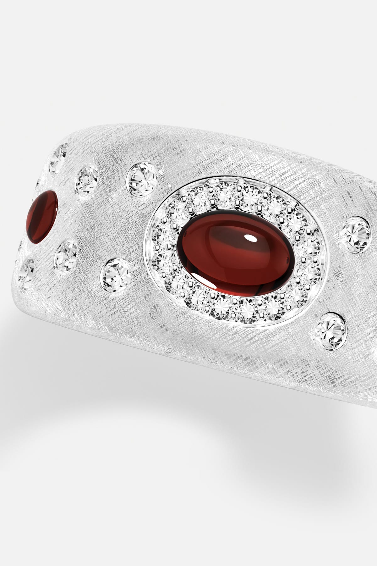 APM Ring in rhodium finish, deep red cabochon aglow with quiet, textured elegance.