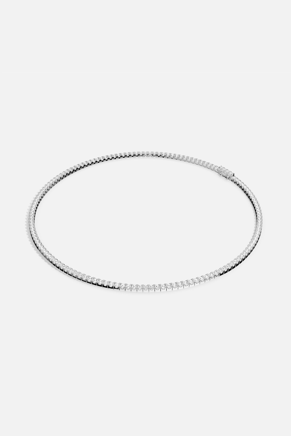 APM Tennis Necklace, a luminous line of brilliance with effortless rhodium finish elegance.