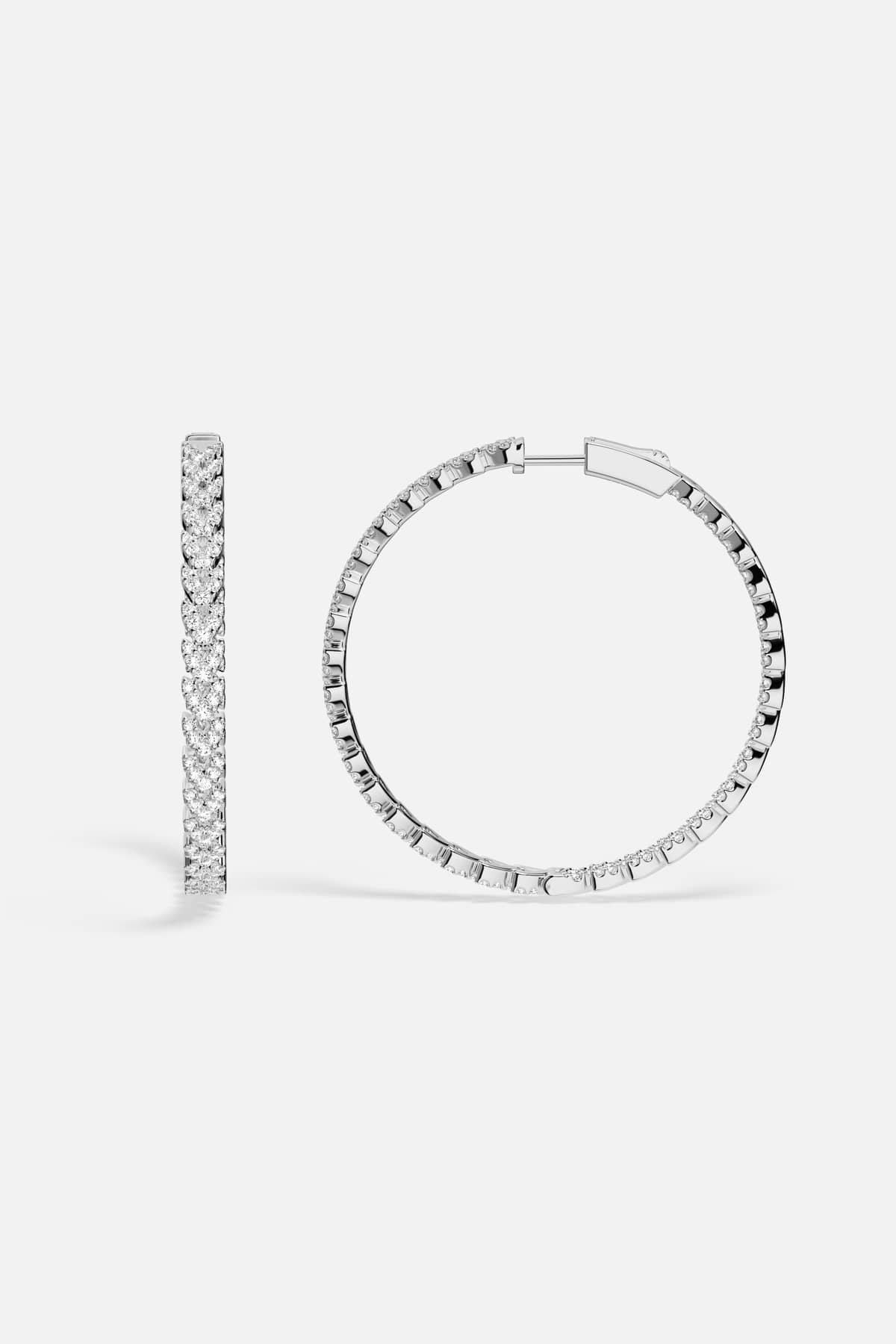 APM Hoop Earrings in rhodium finish, a luminous circle of effortless elegance.
