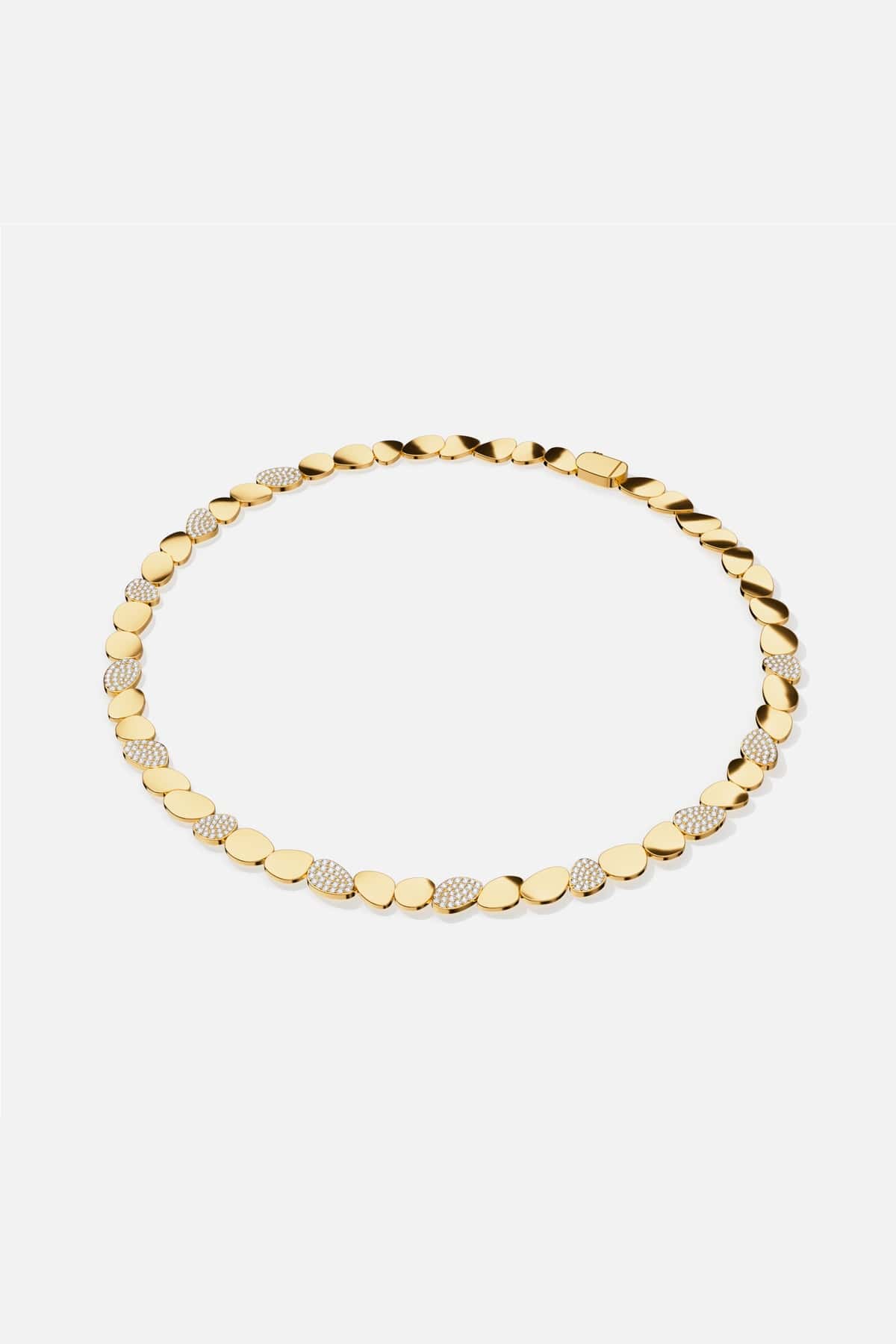 APM Necklace in gold color, a fluid cascade of pebbles shimmering with quiet confidence.