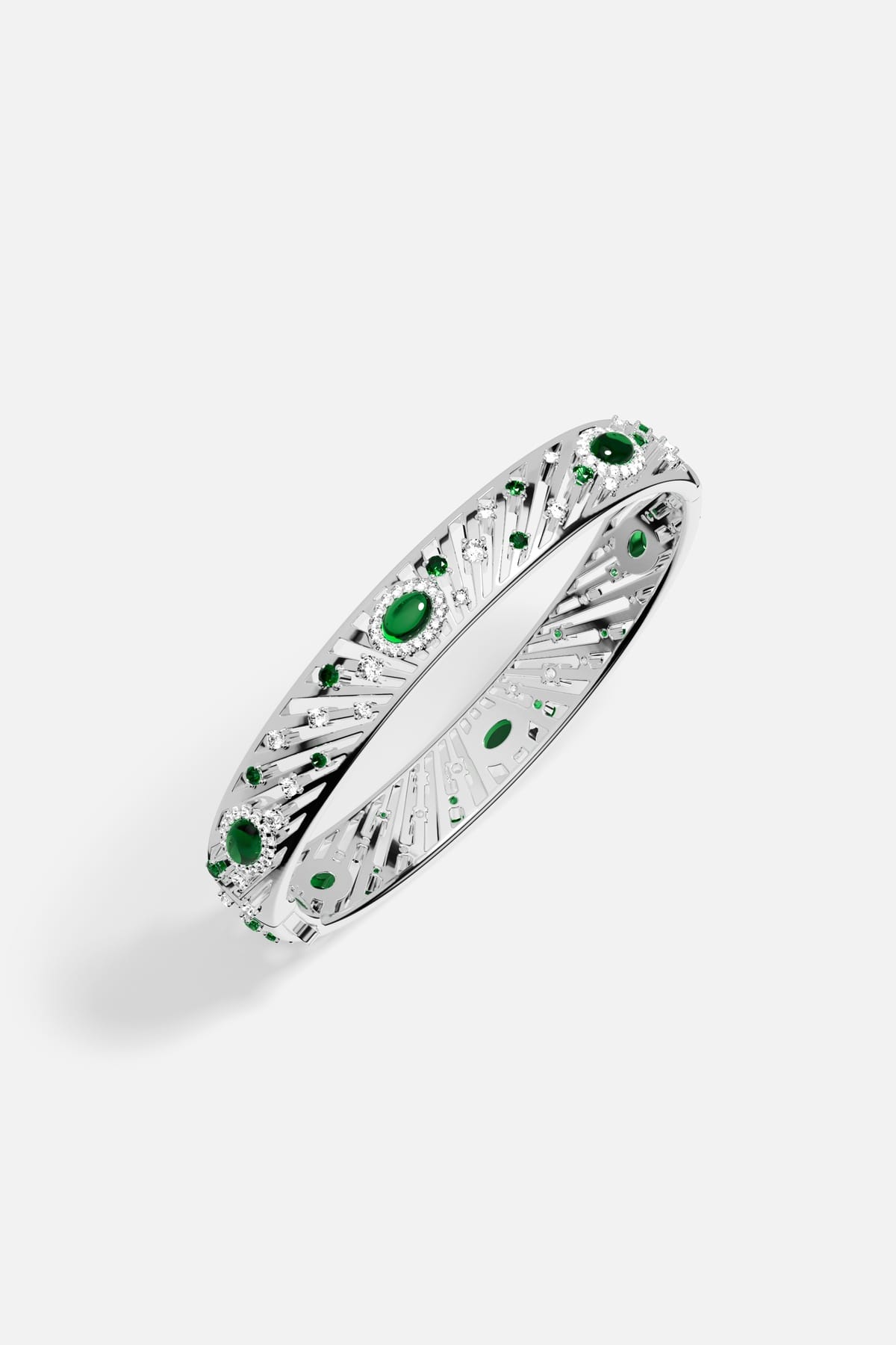 APM Bangle radiating with emerald green stones, a luminous burst of celestial elegance.