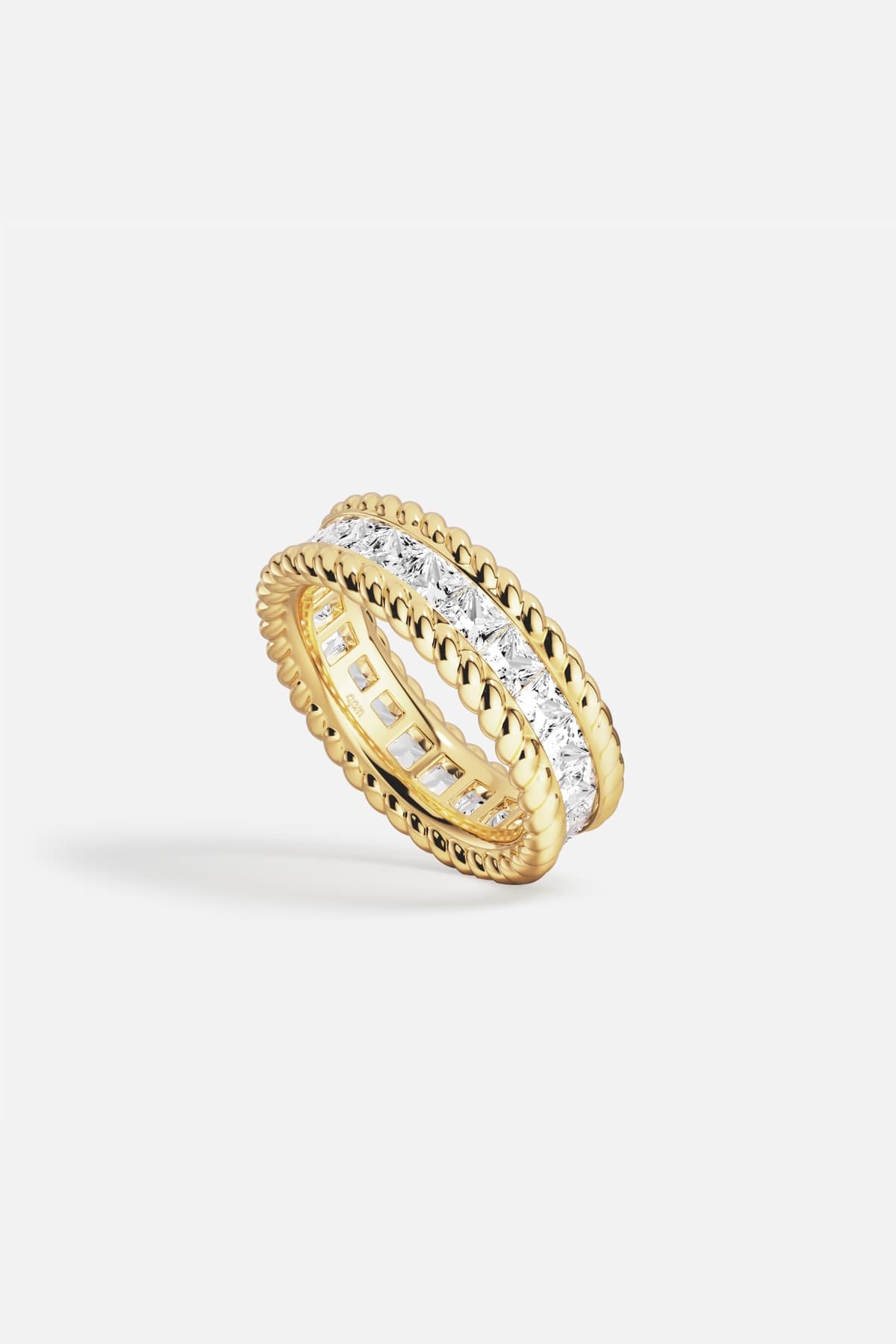 APM Ring in golden color, twisted edges framing brilliance, quiet everyday luxury.