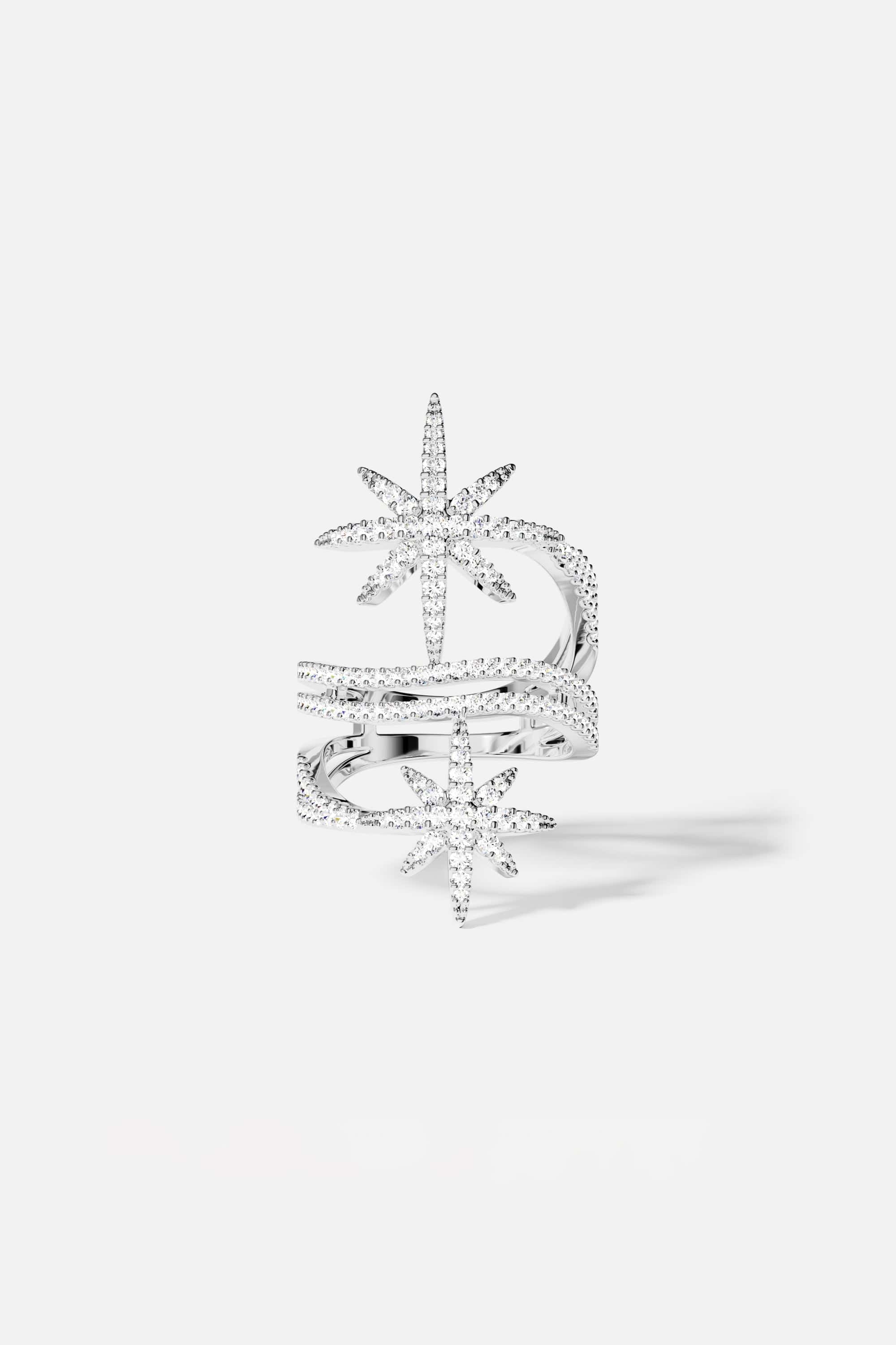 Rings APM Monaco. White metal ring with two star-shaped accents on the band, forming a double-star design.