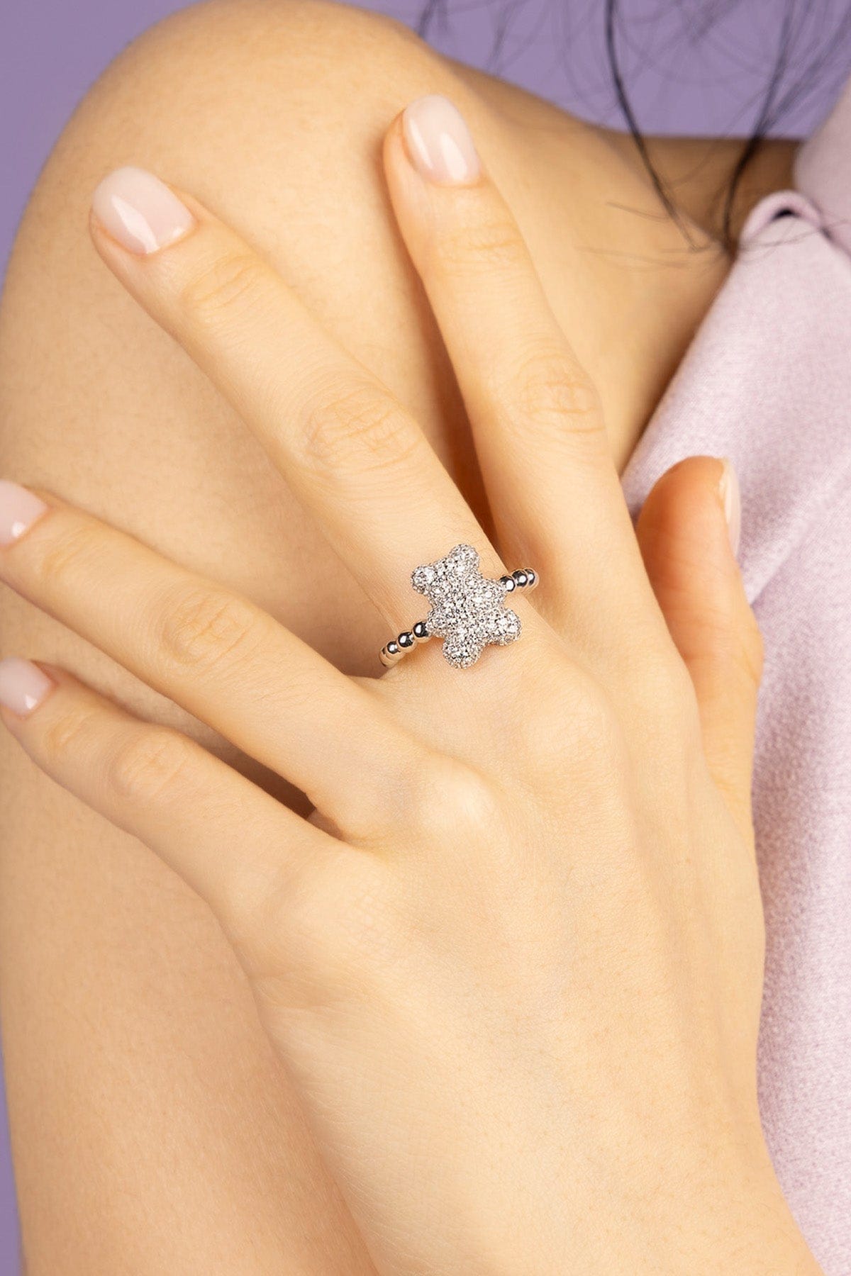 Silver ring with a ZIRCONIA on a hand against a blurred background