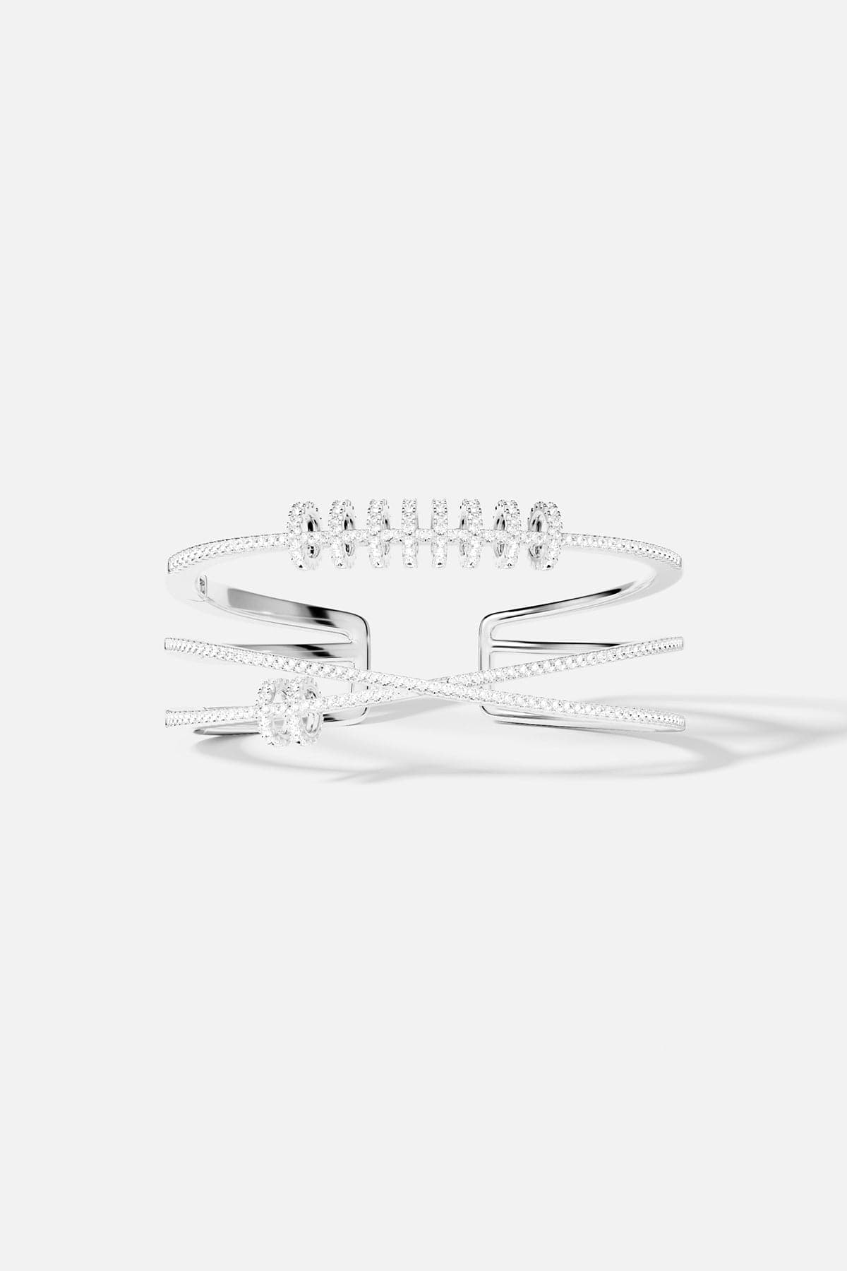 Bracelets APM Monaco: silver-tone triple cuff with sliding rings and pavé embellishments.