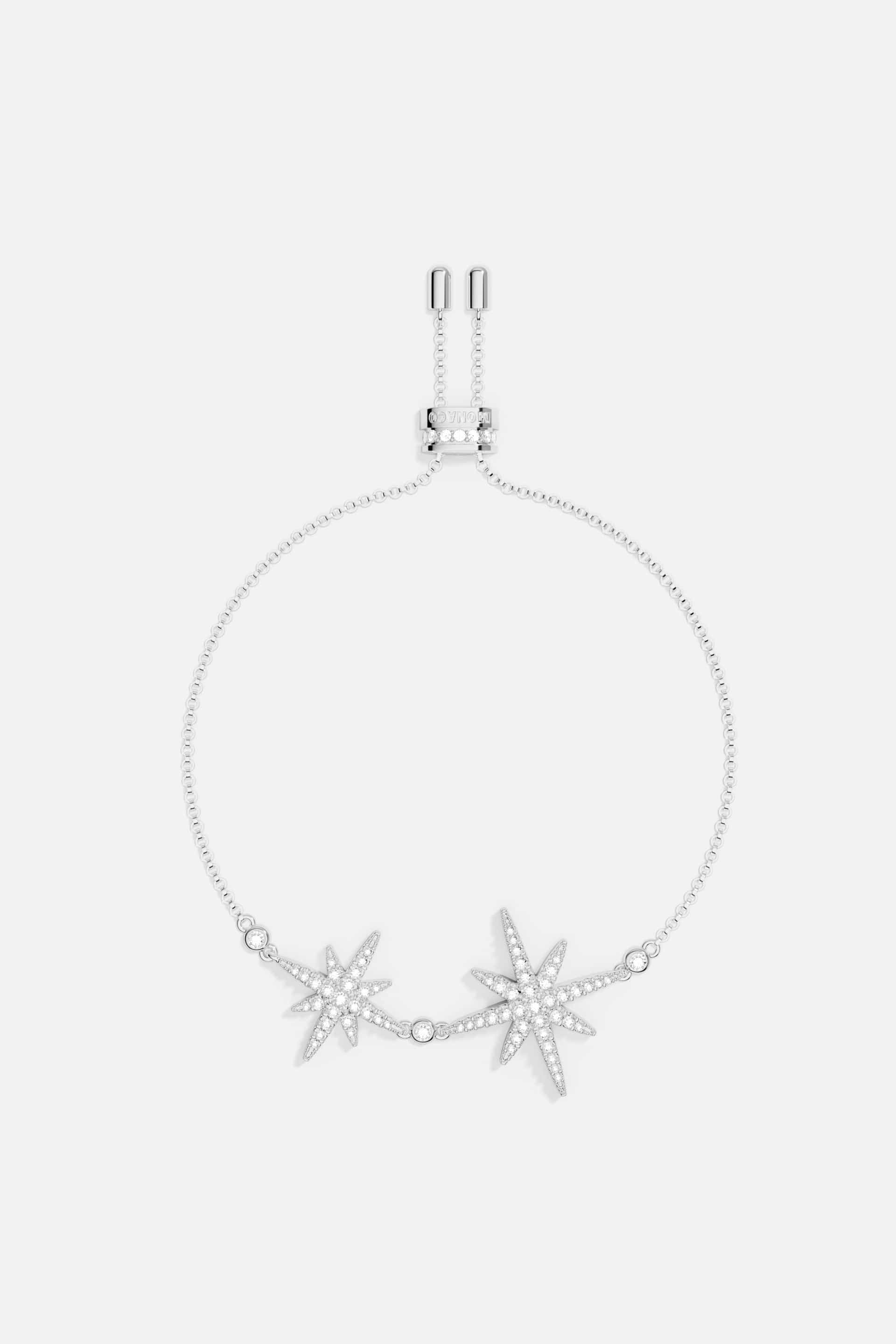 Bracelets APM Monaco: silver-tone charm bracelet with two jeweled starburst charms.