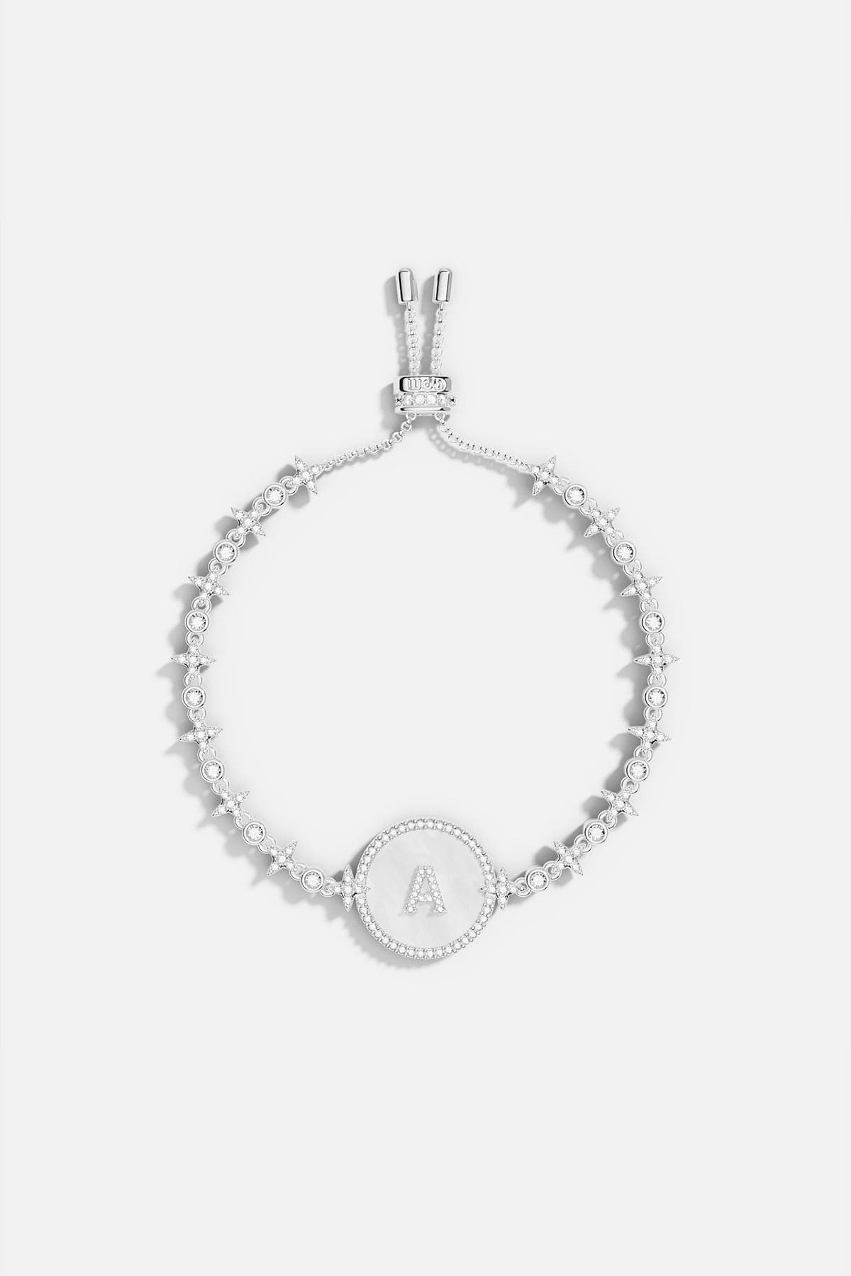 Bracelets APM Monaco, alphabet eternelle adjustable bracelet in silver with a circular focal charm.