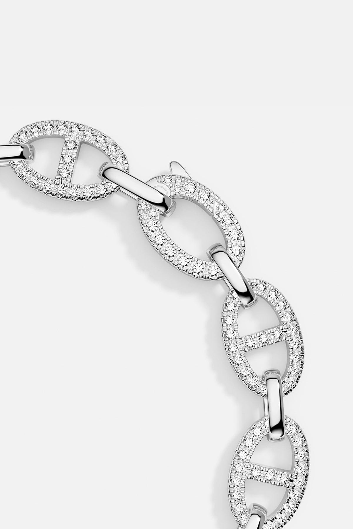 Silver bracelet with interlocking links on a light gray background
