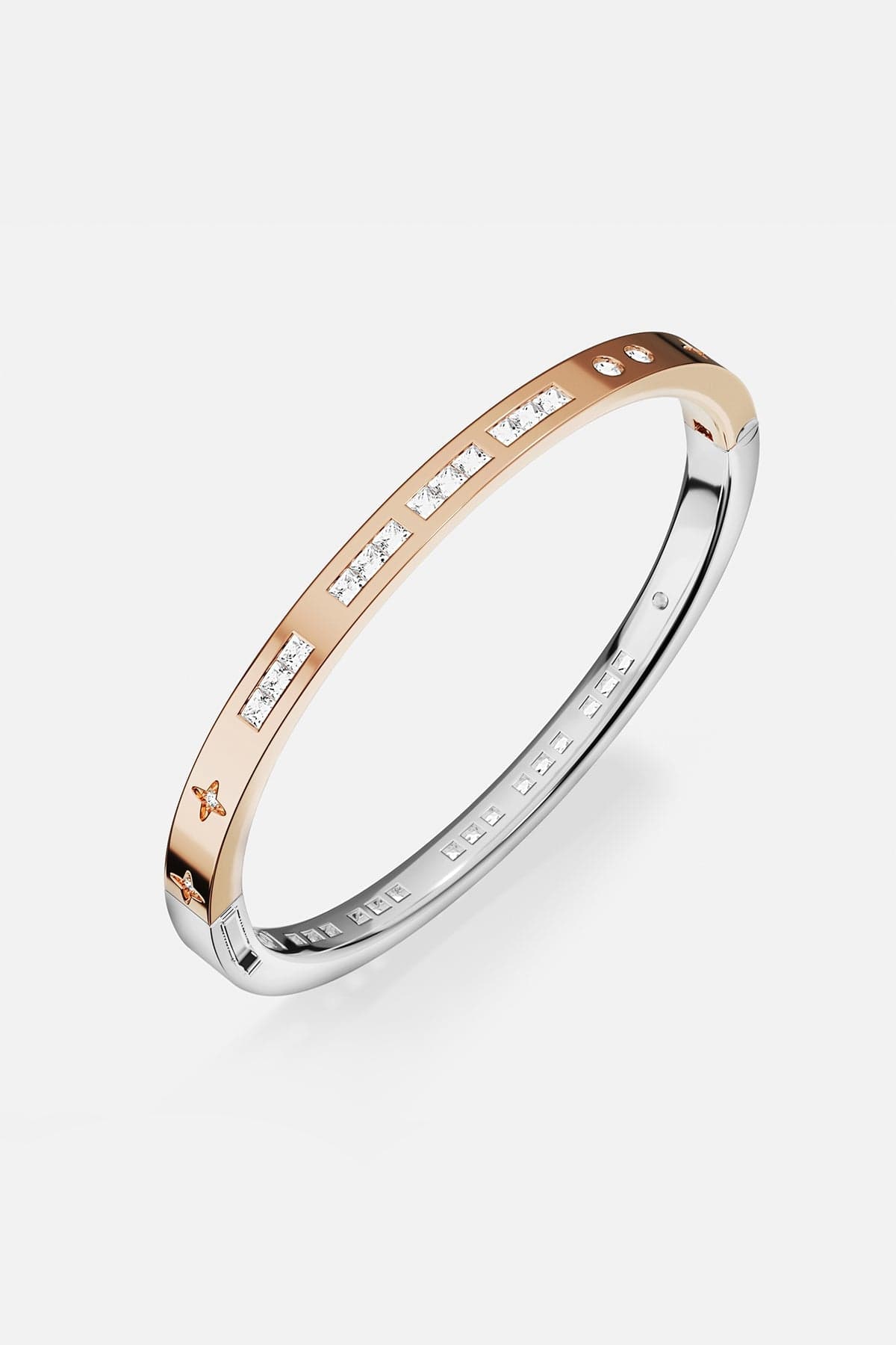 Bracelets APM Monaco two-tone gold and silver bangle with inlaid white stones.
