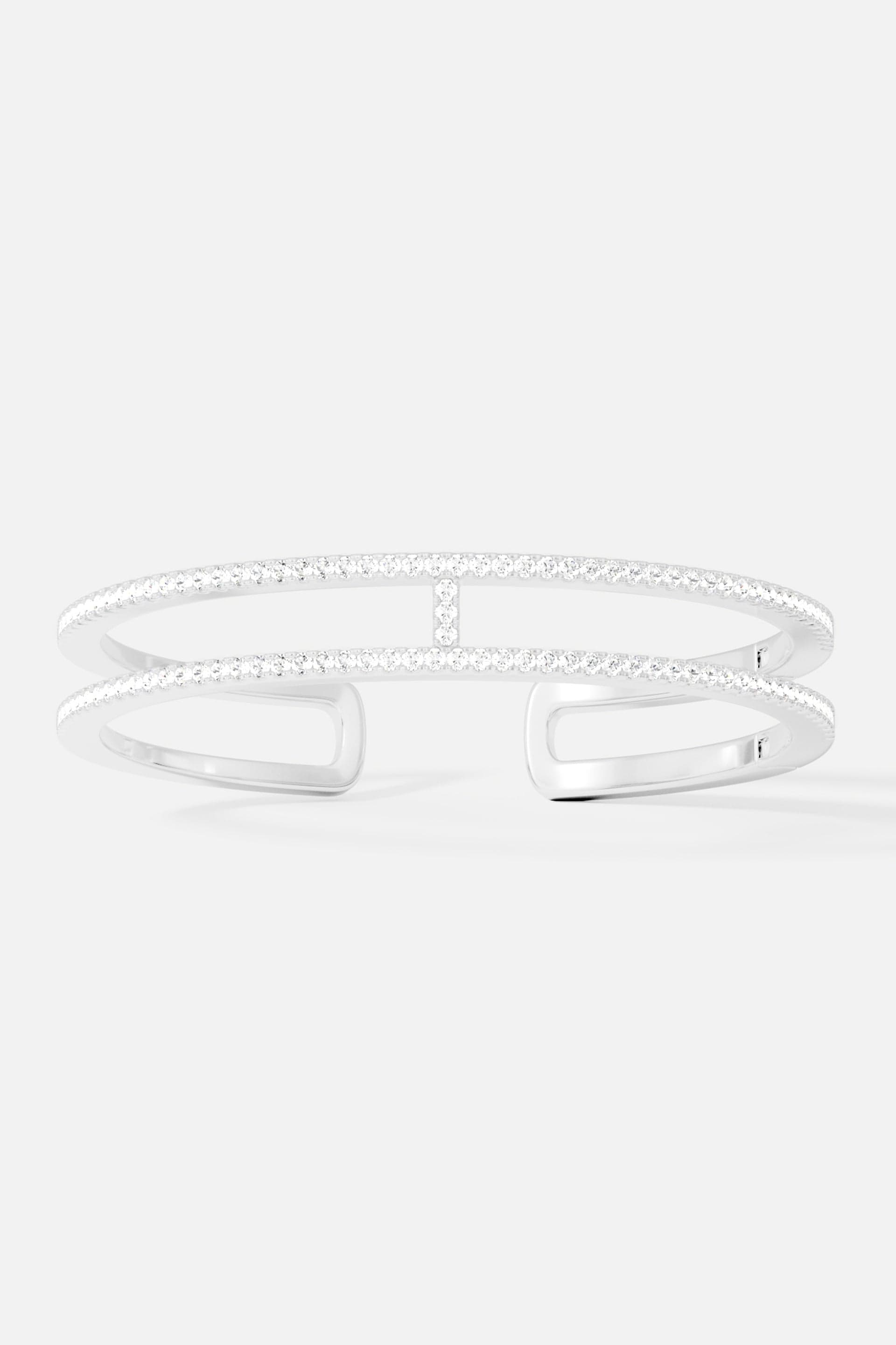 Bracelets APM Monaco, double-line pavé cuff bangle in white/silver tone with multiple rows of diamonds.