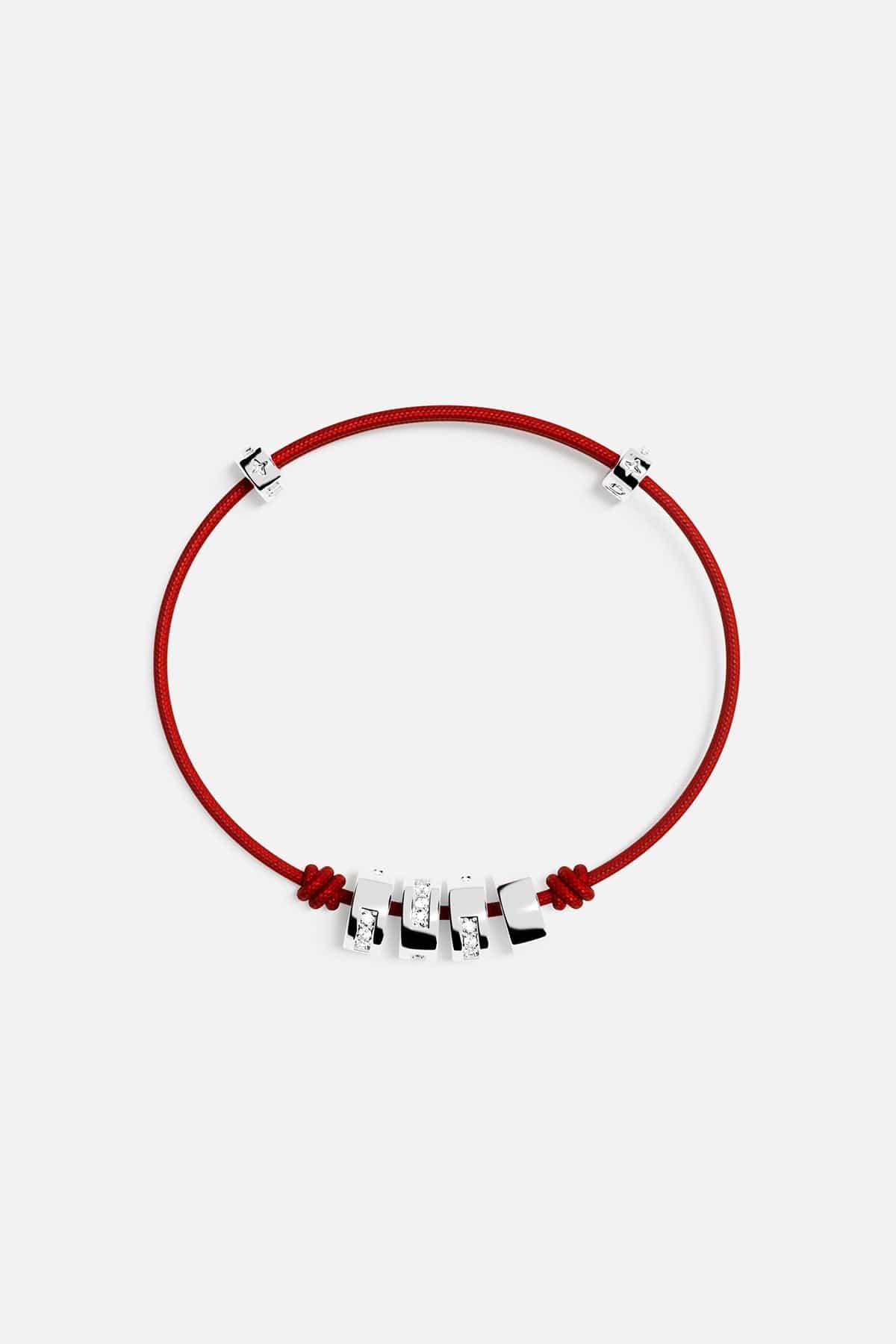 Bracelets APM Monaco morse-code string bracelet with red cord and four silver beads, three with pavé diamonds.