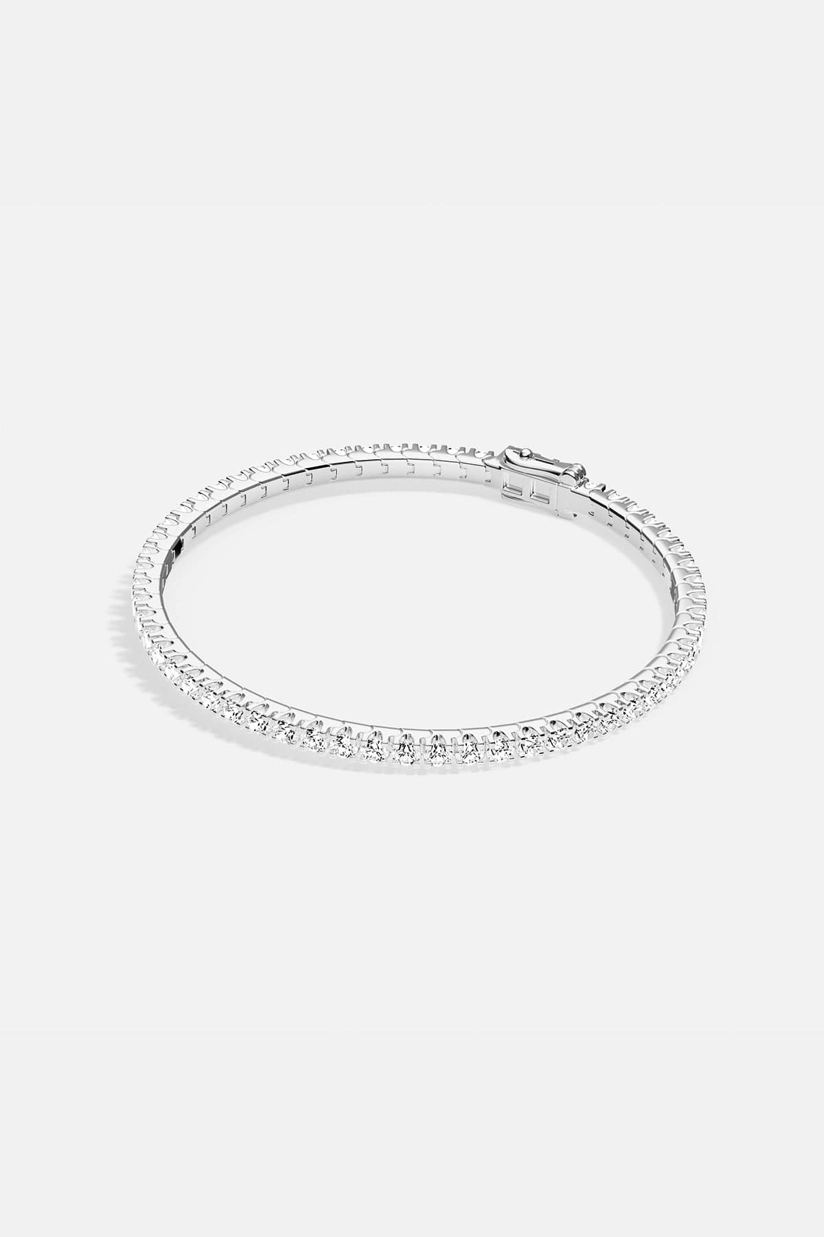 Bracelets APM Monaco pavé white stones on a silver-tone bracelet.