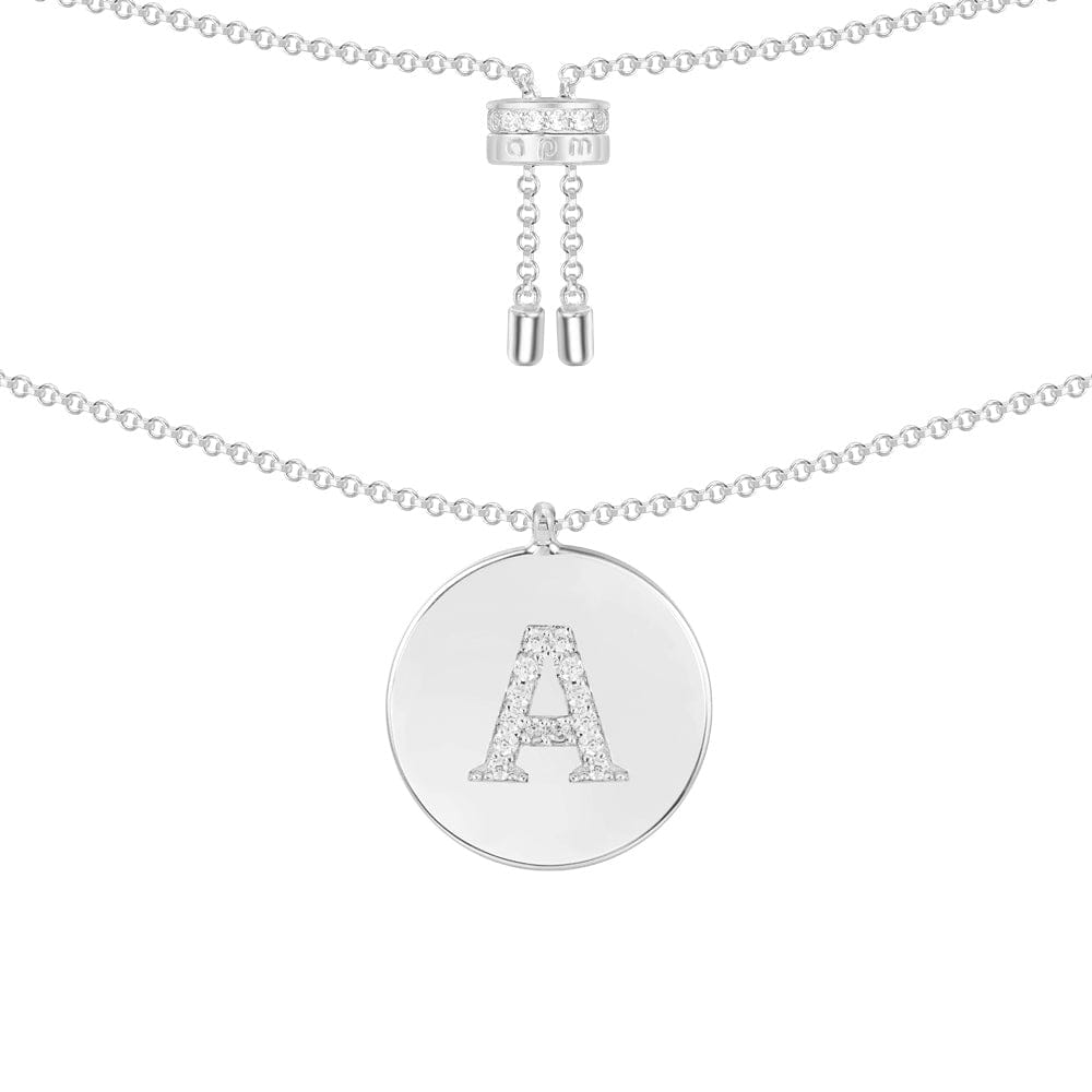 Necklaces APM Monaco. Silver-tone chain with a round pendant bearing a capital A made of diamonds.